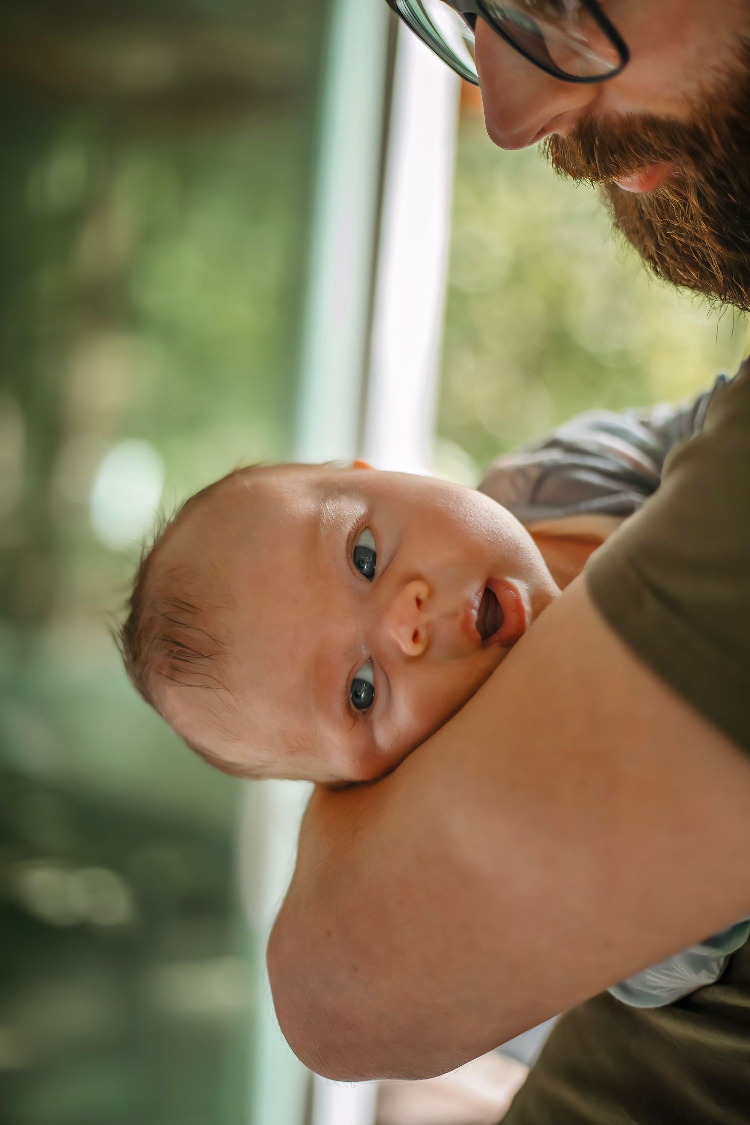 At-home newborn photo session in Santa Cruz, capturing a family’s intimate, candid moments with warmth and heartfelt connection