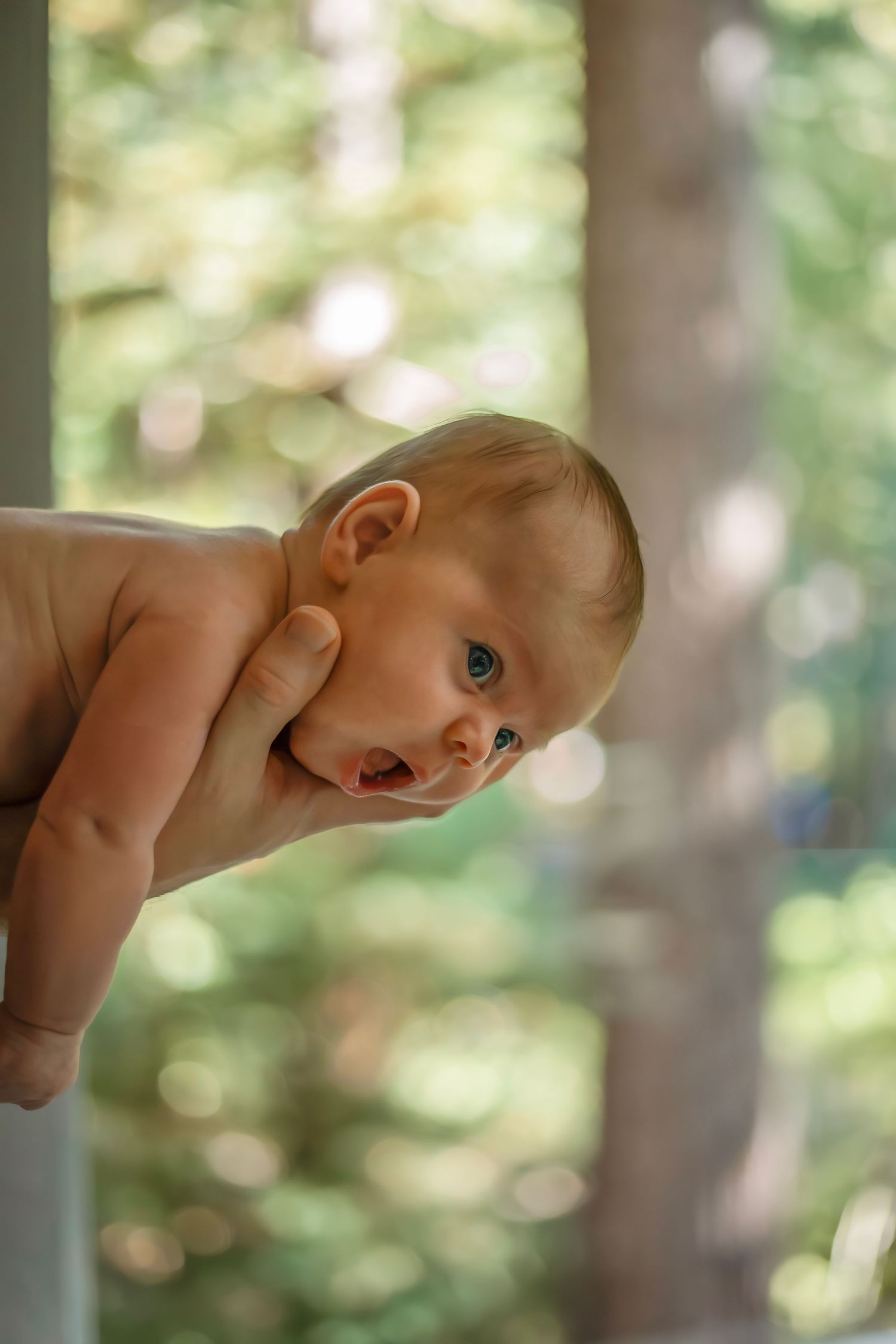 At-home newborn photo session in Santa Cruz, capturing a family’s intimate, candid moments with warmth and heartfelt connection