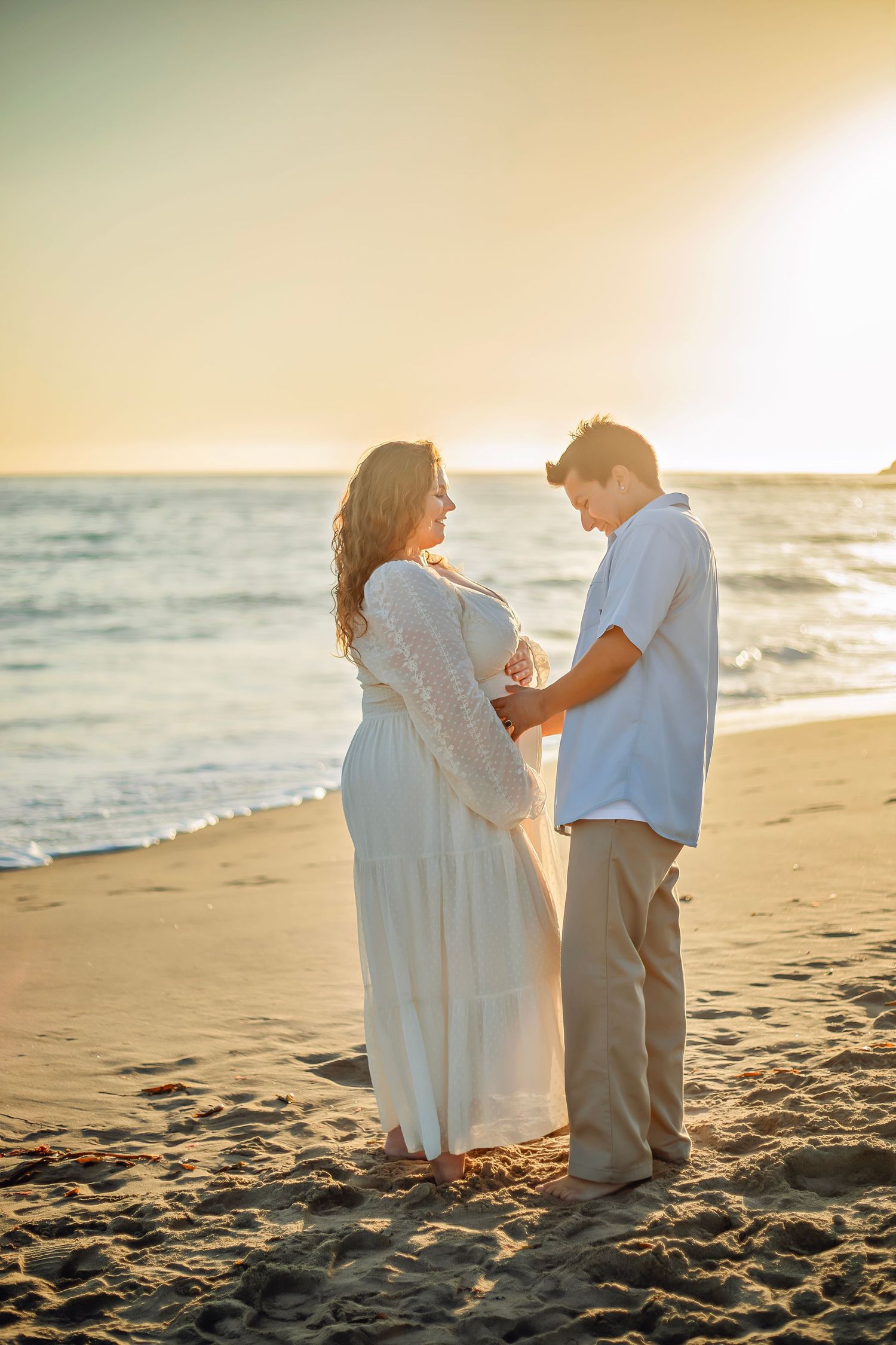 Family maternity photo session at a Santa Cruz beach, candid moments, ocean views, and a warm, relaxed coastal atmosphere.