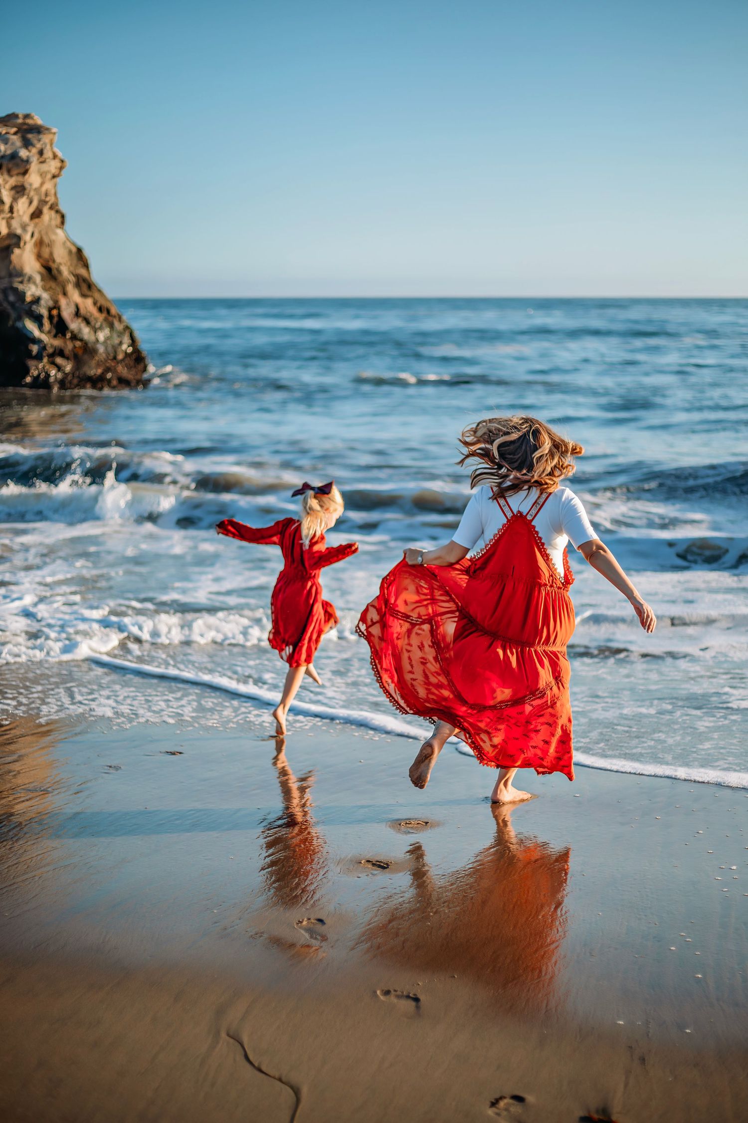 Family enjoying at the beach in Santa Cruz, captured in natural light with candid moments, ocean views, and a relaxed coastal setting