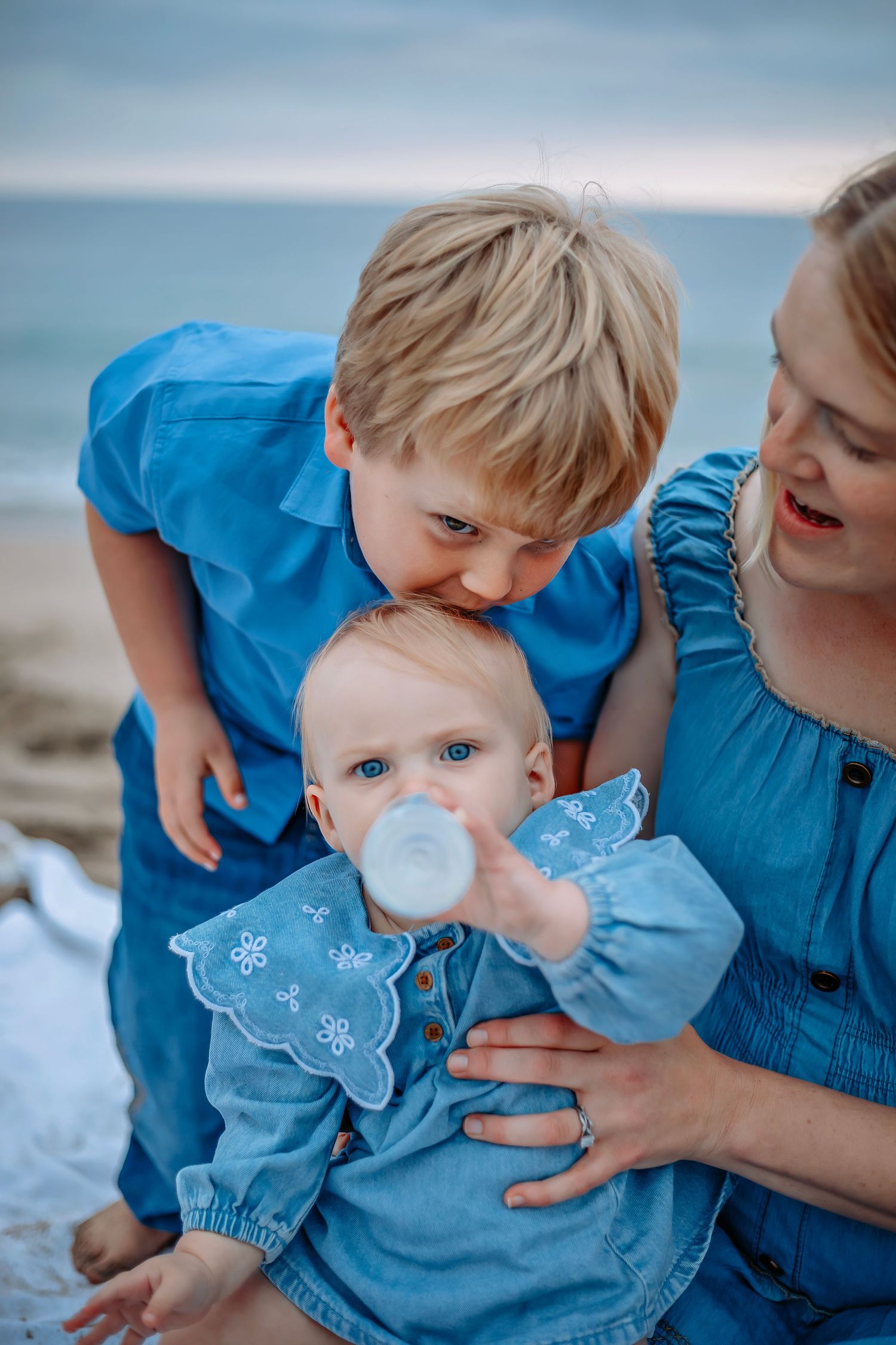 Siblings enjoying a beach in Santa Cruz, captured in natural light with candid moments, ocean views, and a relaxed coastal setting