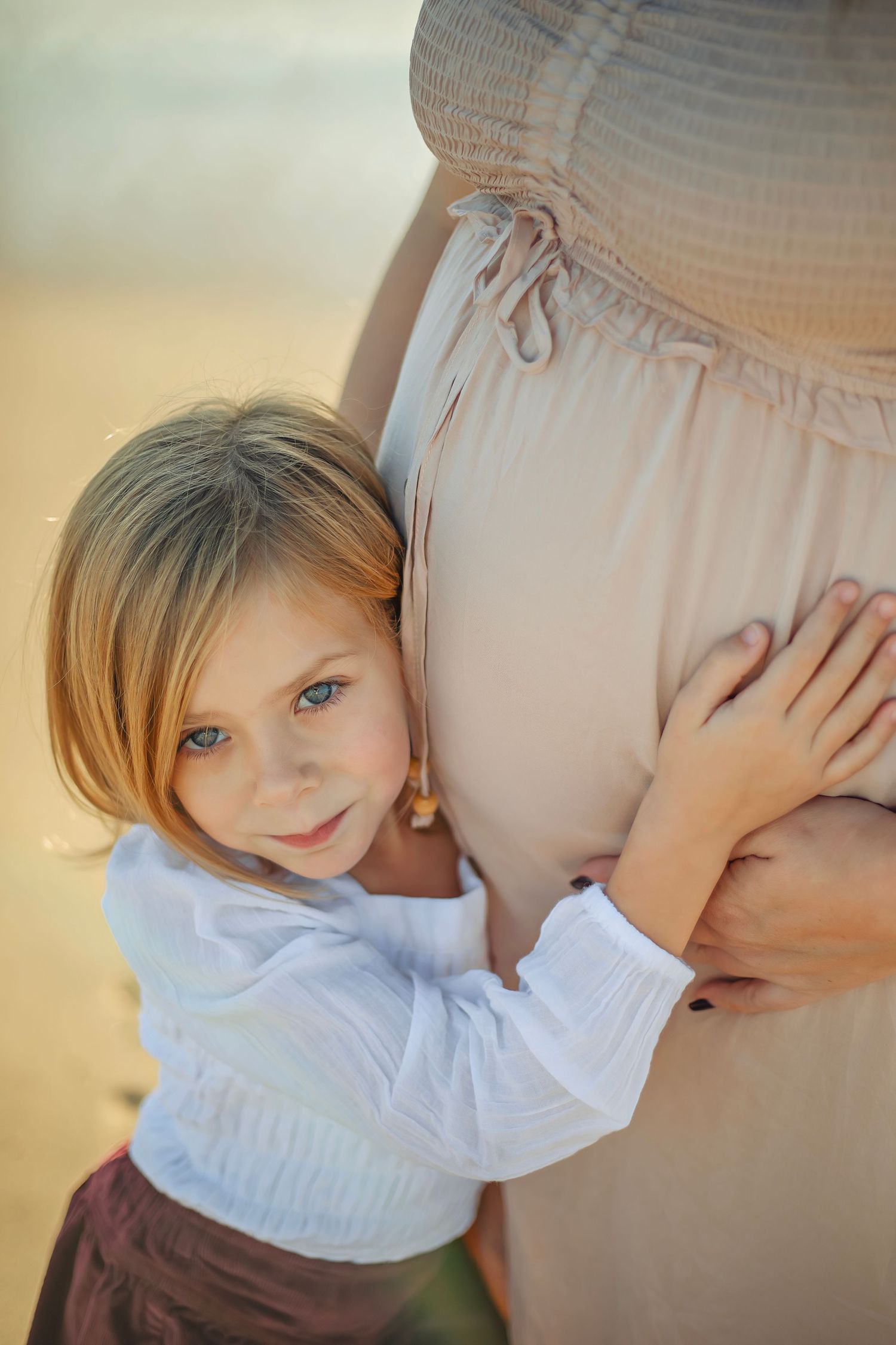 Family maternity photo session at a Santa Cruz beach, candid moments, ocean views, and a warm, relaxed coastal atmosphere.