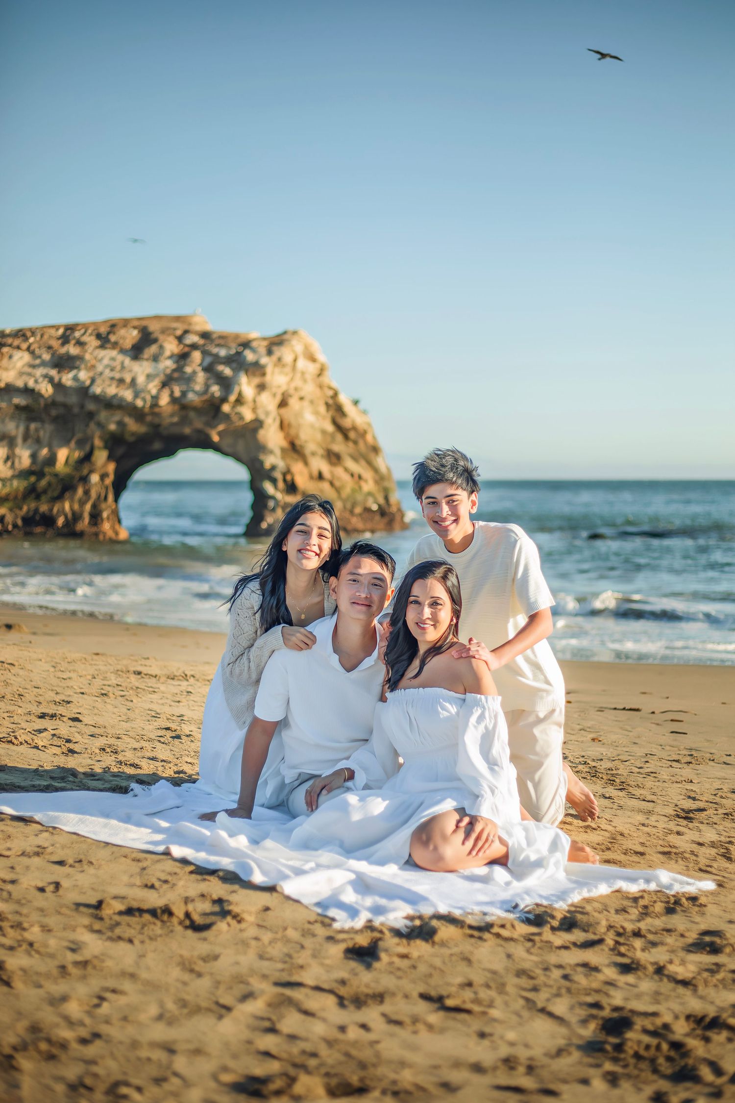 Family enjoying at the beach in Santa Cruz, captured in natural light with candid moments, ocean views, and a relaxed coastal setting