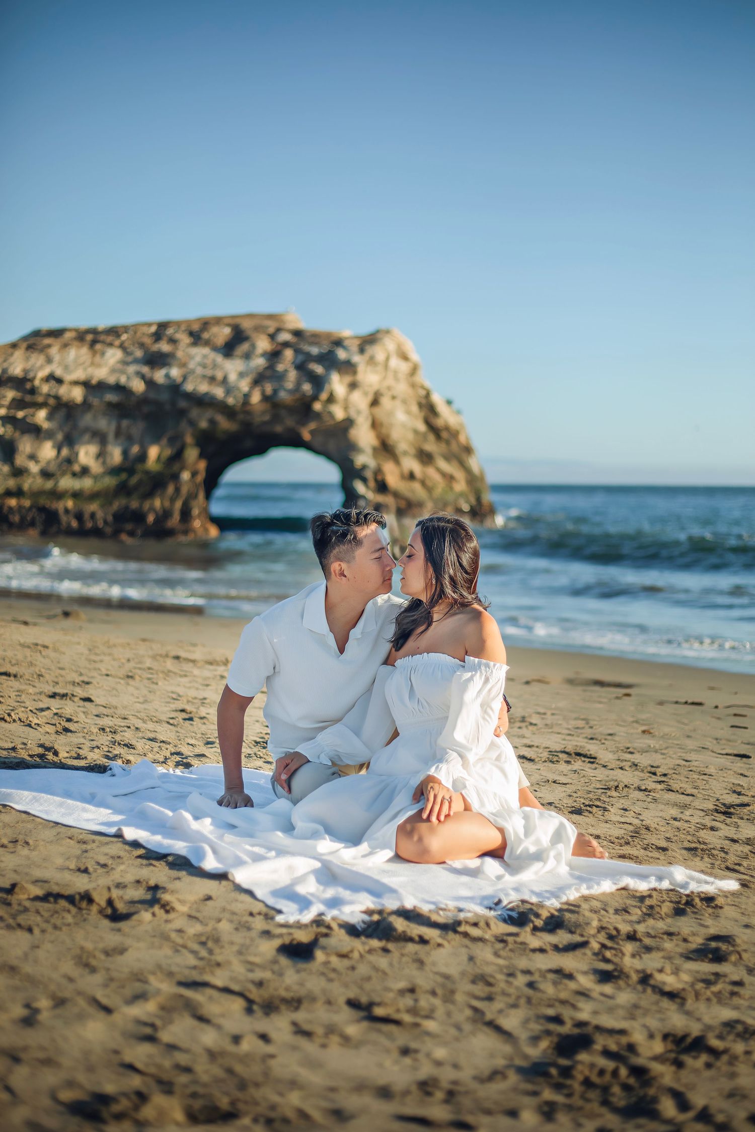 A couple enjoying at the beach in Santa Cruz, captured in natural light with candid moments, ocean views, and a relaxed coastal setting