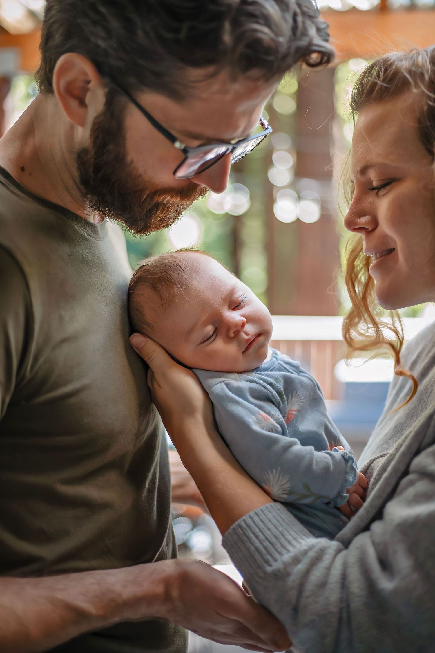 At-home newborn photo session in Santa Cruz, capturing a family’s intimate, candid moments with warmth and heartfelt connection