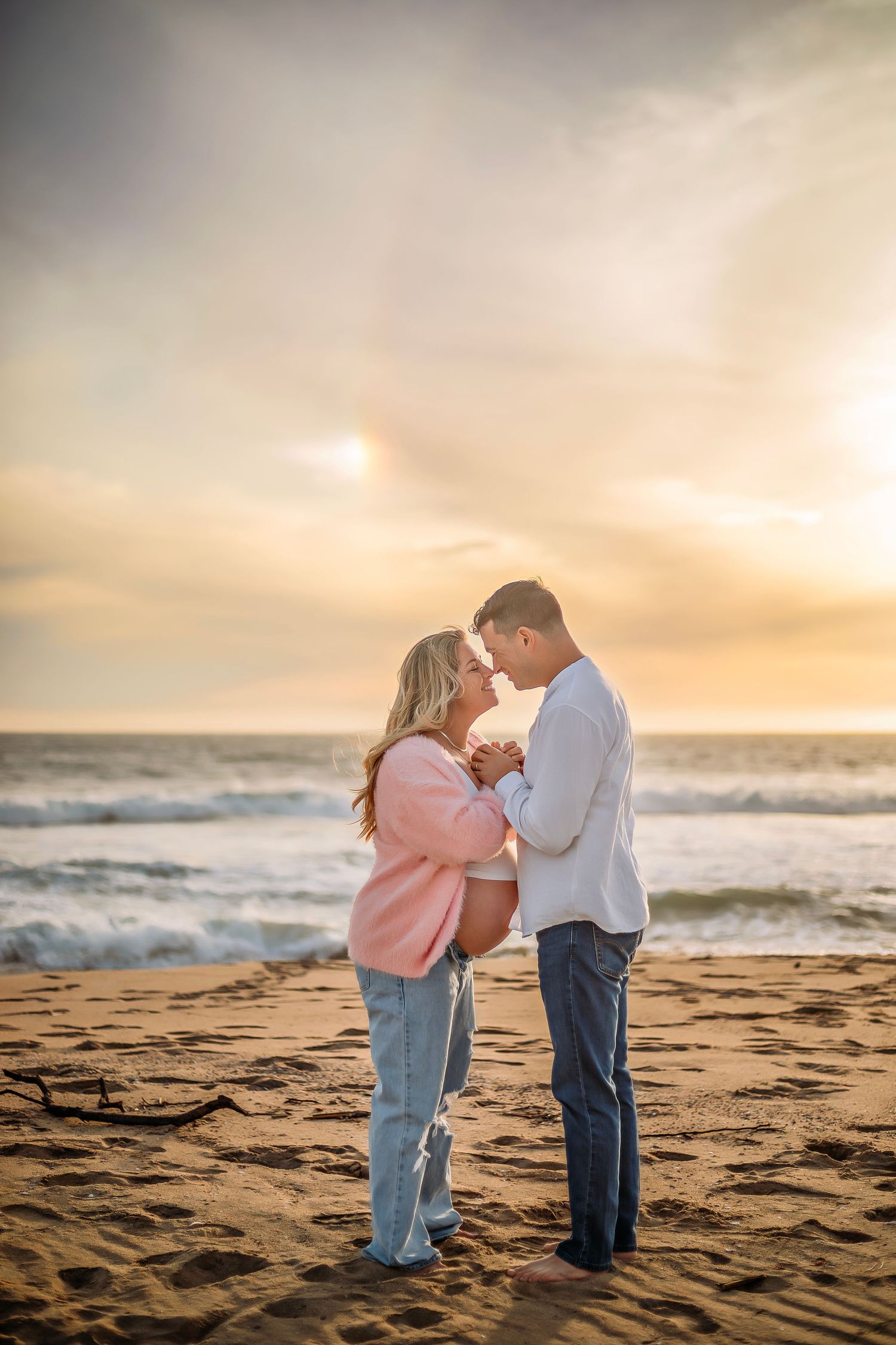 Candid maternity portrait during an outdoor photography session at a beach in Santa Cruz in fall/autumn
