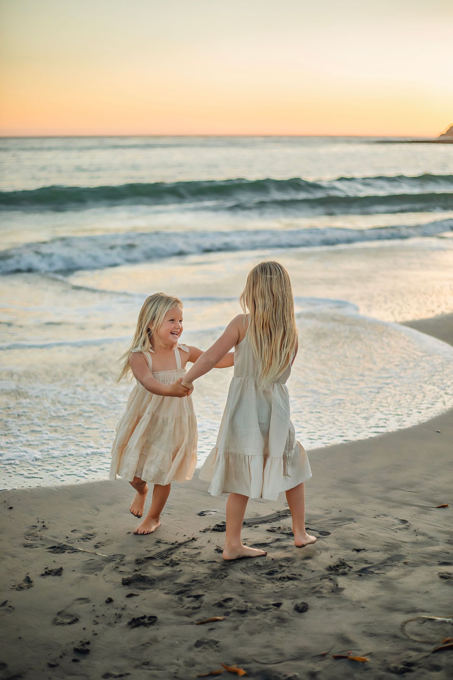 Children playing at the beach in Santa Cruz during golden hour, captured in natural light with candid, joyful moments and coastal scenery.