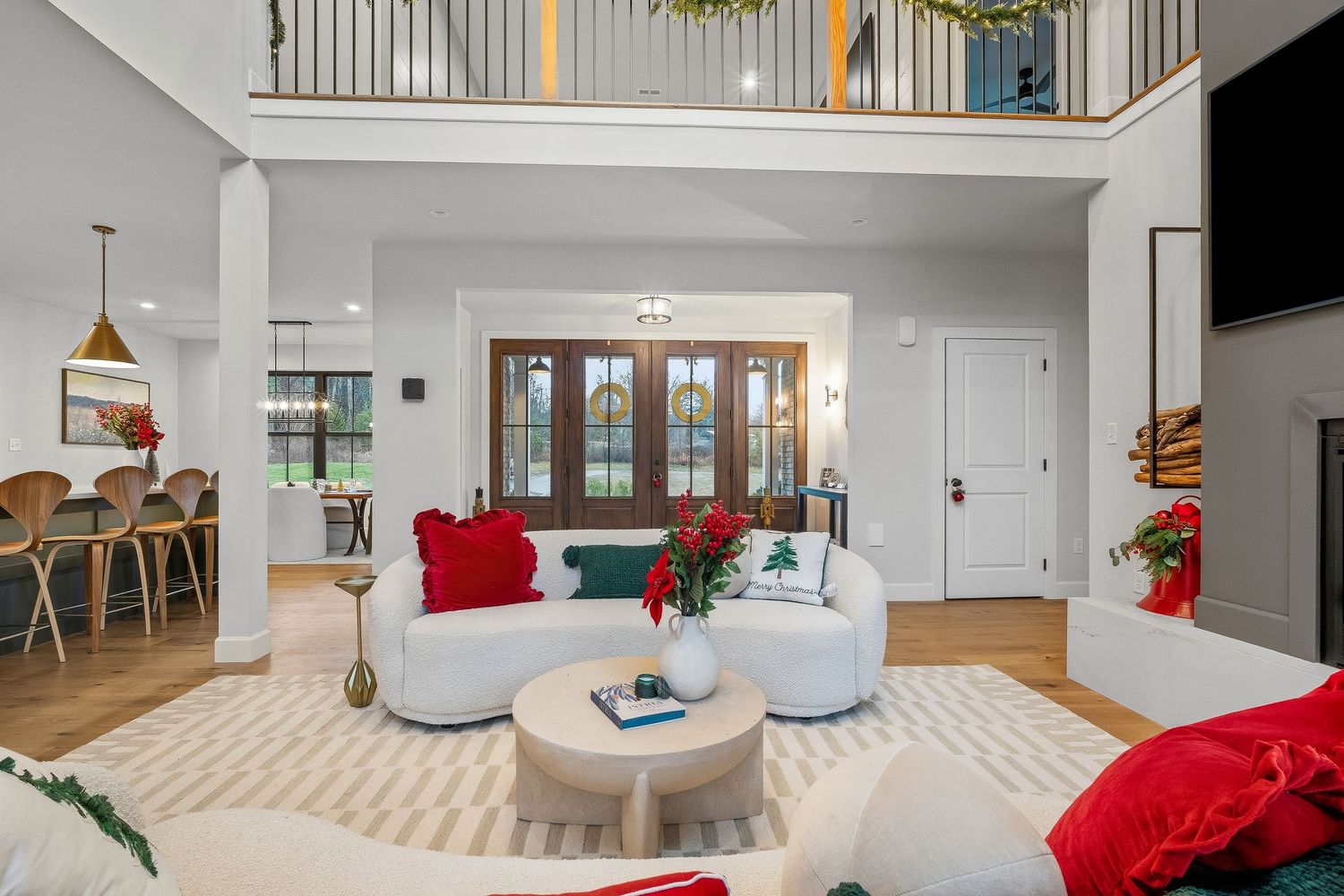 Spacious living room with high ceilings, balcony overlook, modern furnishings, and open layout, photographed for residential real estate lis