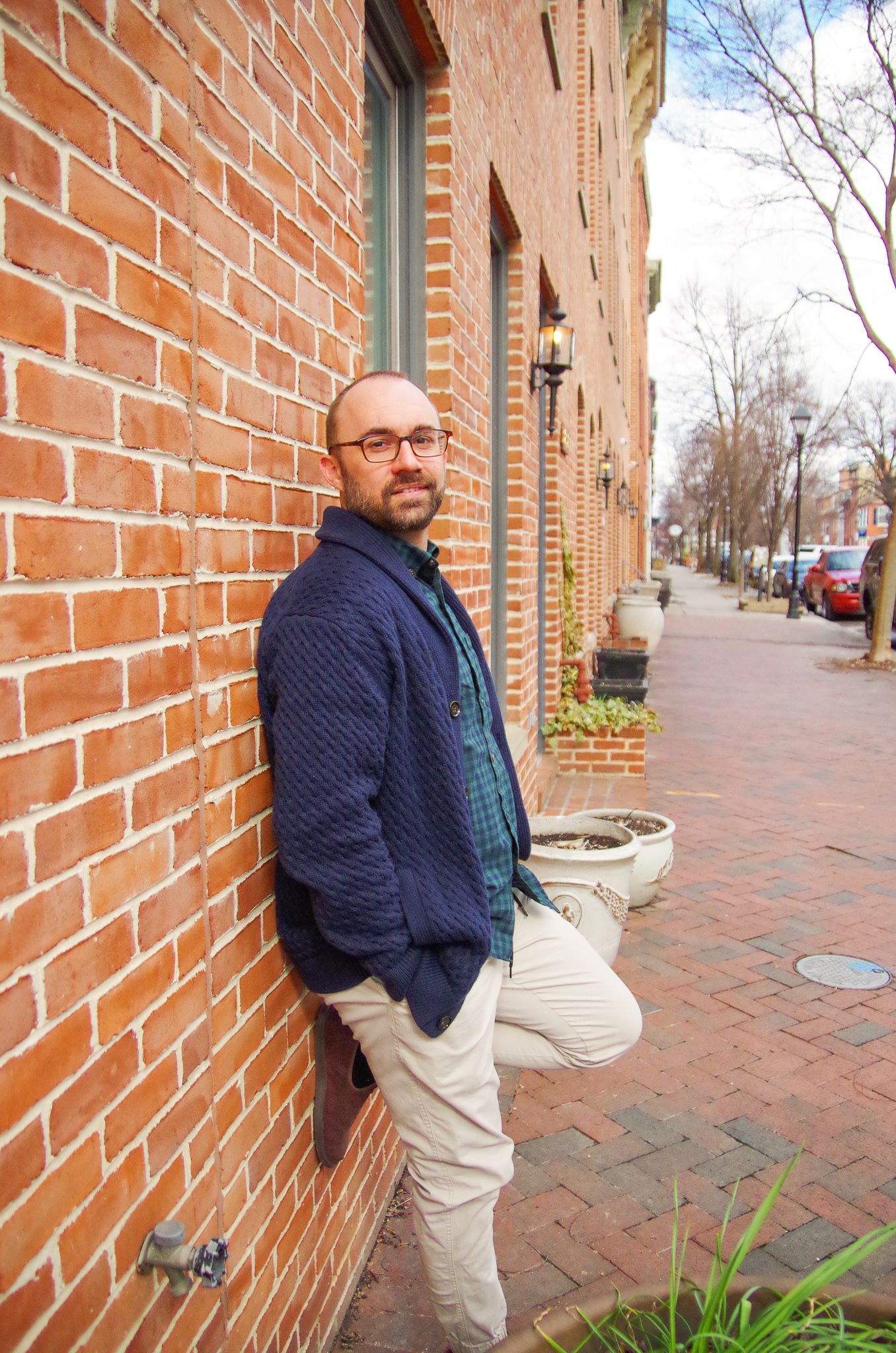 Branding photo of man against brick wall in Fells Point, MD