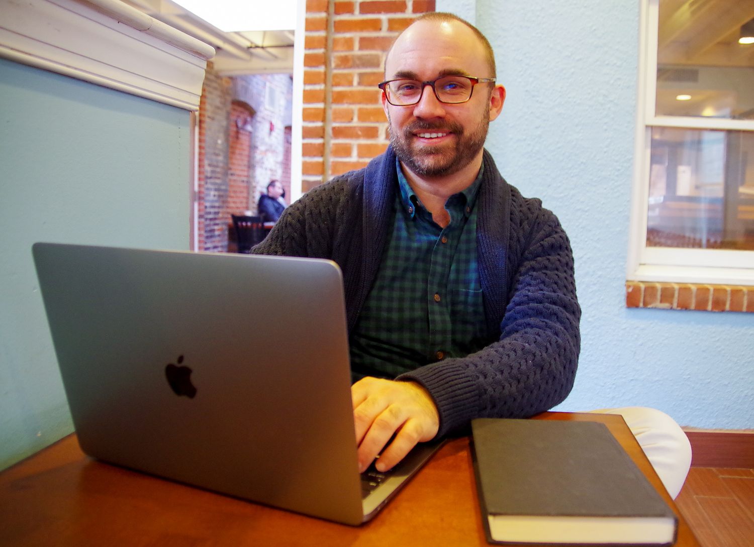 Branding business photo of man on his laptop in Fells Point, MD