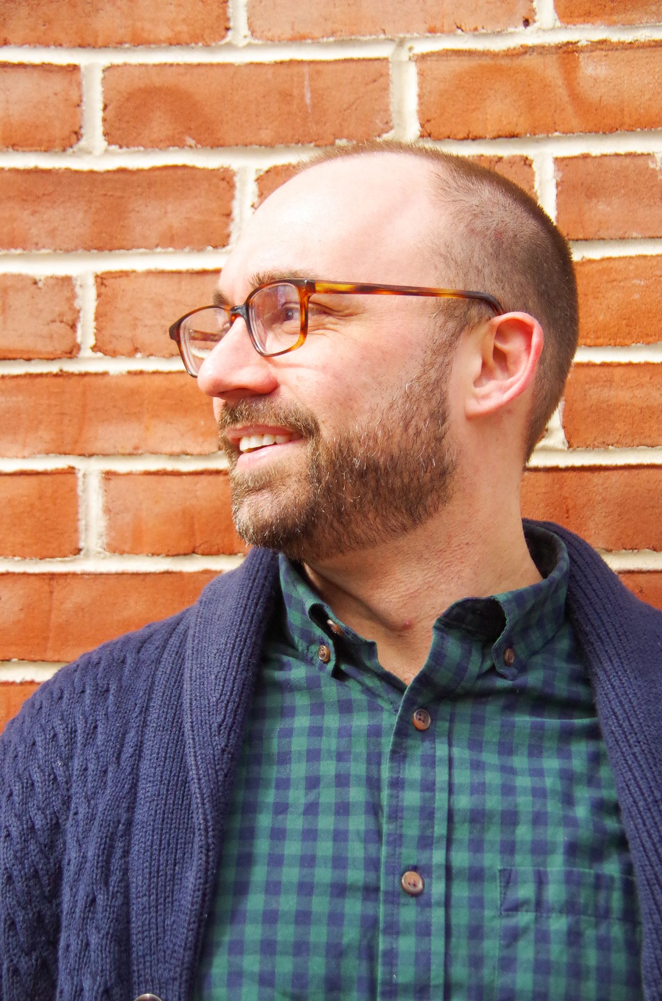Branding business photo of man against brick wall in Fells Point, MD