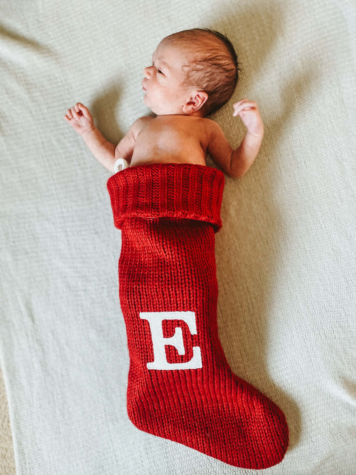 Newborn baby photo session with baby in Christmas stocking in Baltimore, MD