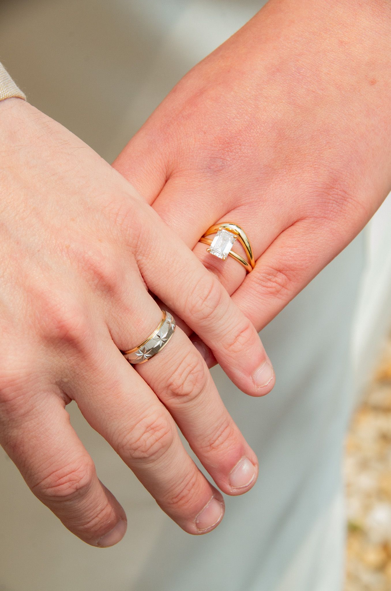 Wedding photo of the rings on bride and grooms hands in Baltimore, MD