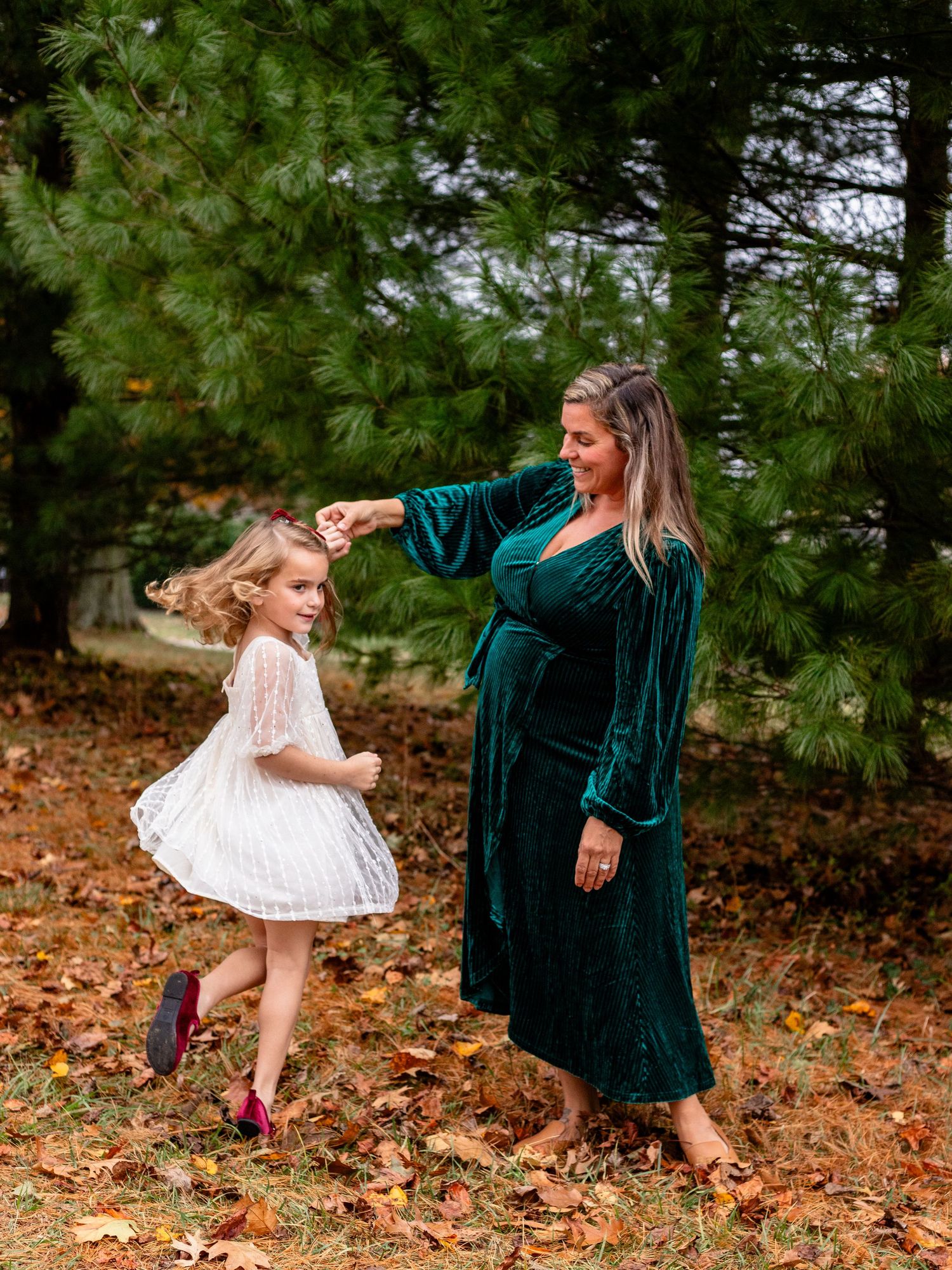 Mom twirling daughter around during family photo session in Baltimore, MD