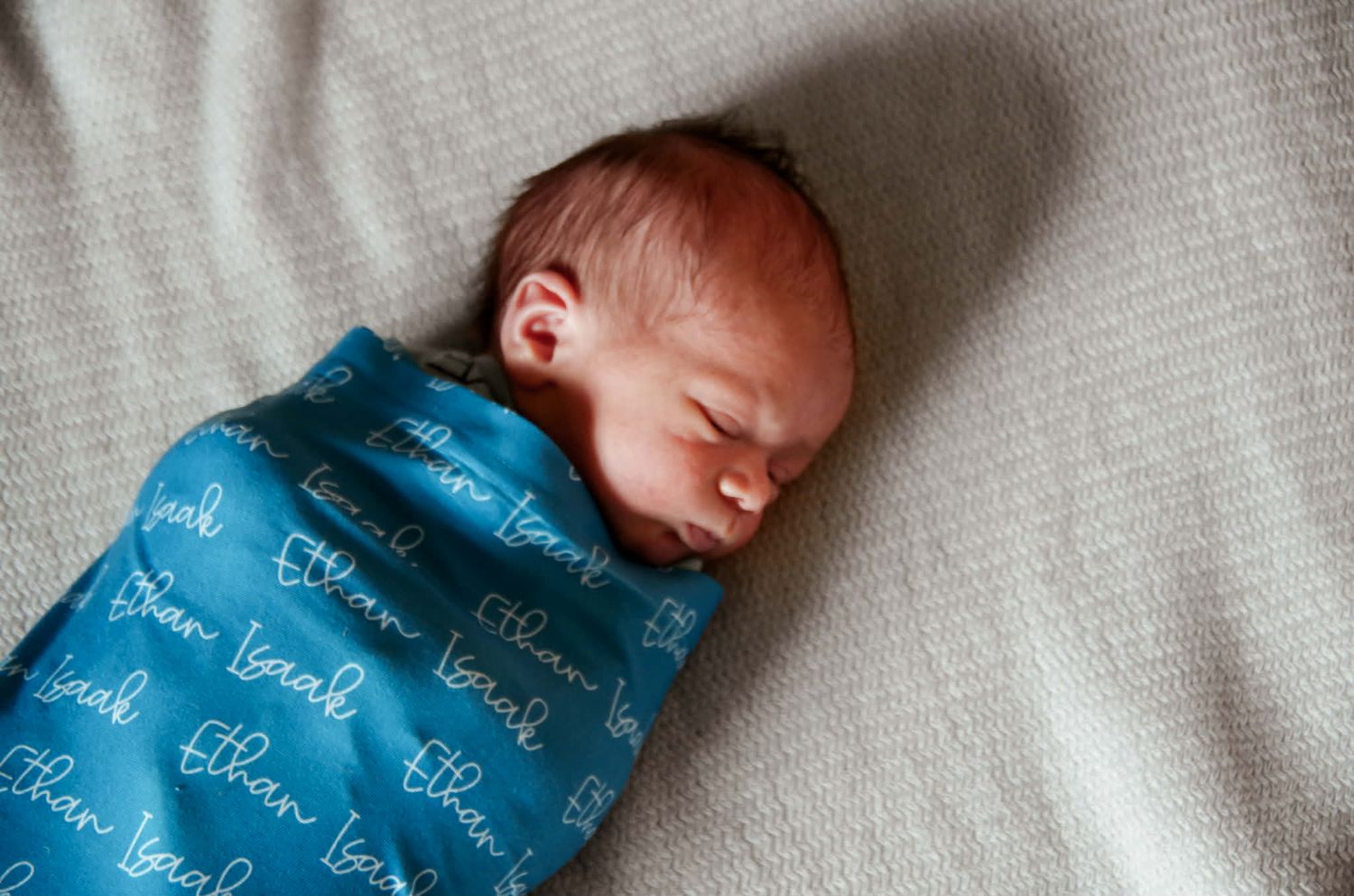 Newborn baby photo session with baby in swaddle in Baltimore, MD