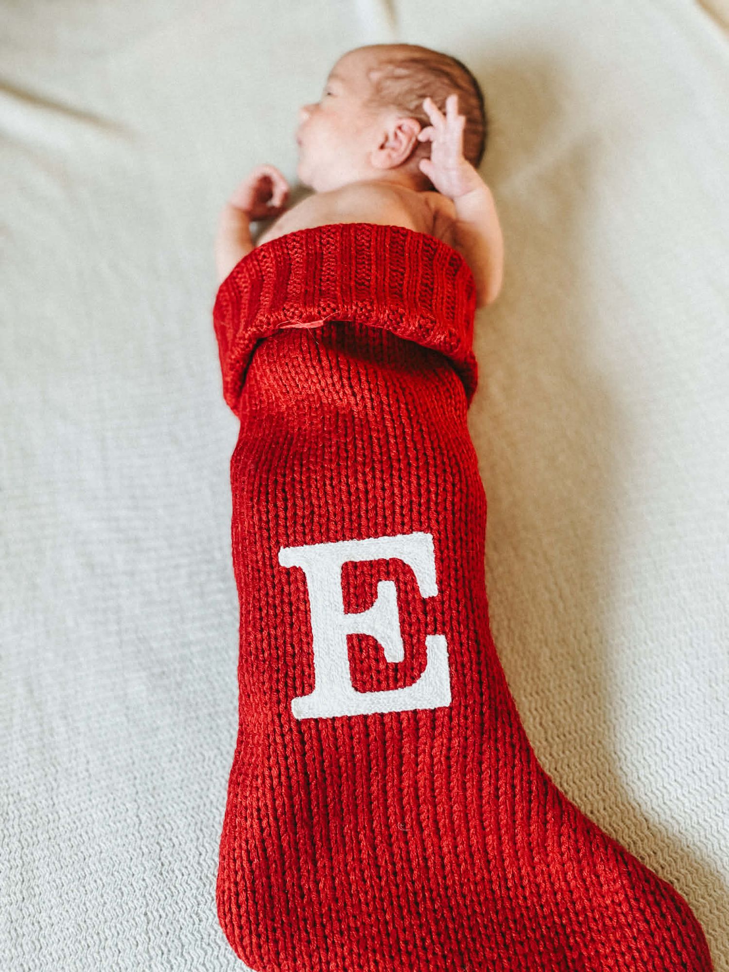 Newborn baby photo session with baby in Christmas stocking in Baltimore, MD