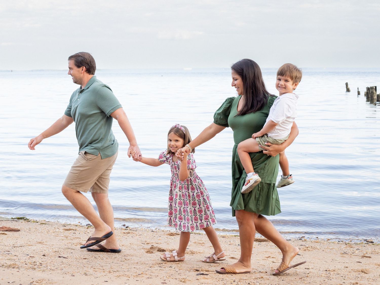 Family of four walking by the Chesapeake Bay in Middle River, MD
