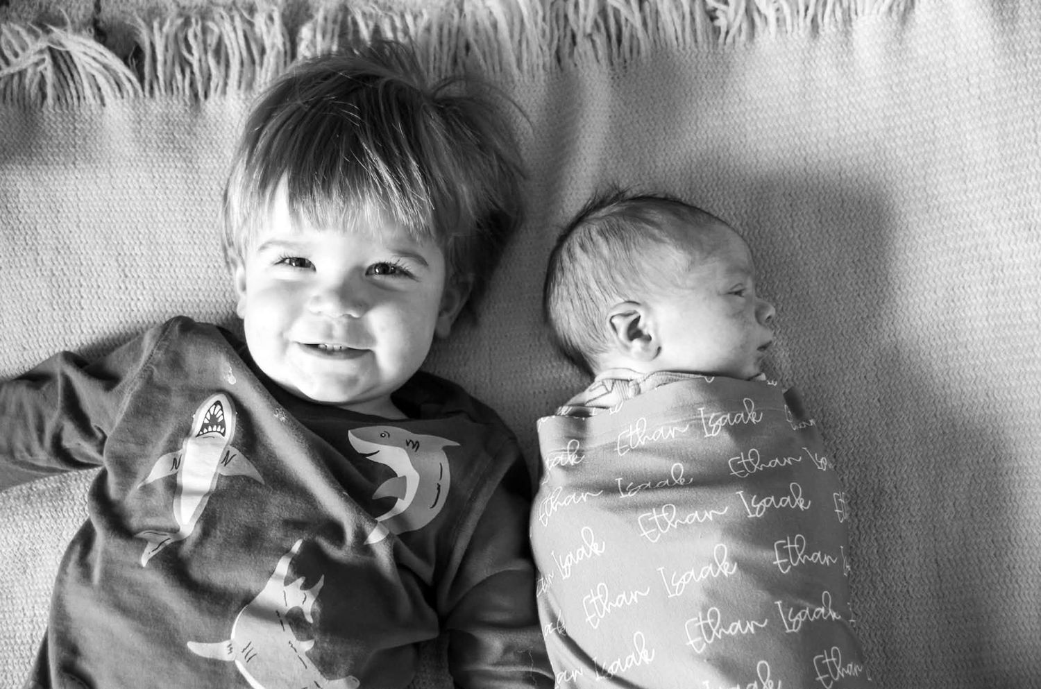 Newborn baby photo session with baby in swaddle with big brother in Baltimore, MD