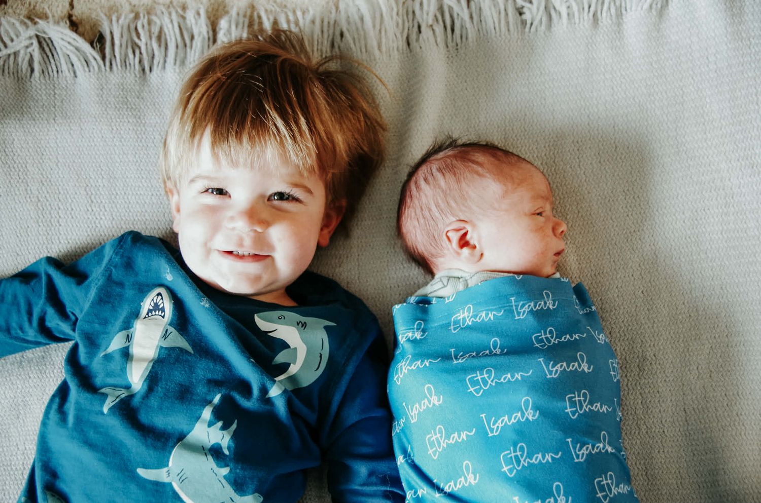 Newborn baby photo session with baby in swaddle with big brother in Baltimore, MD