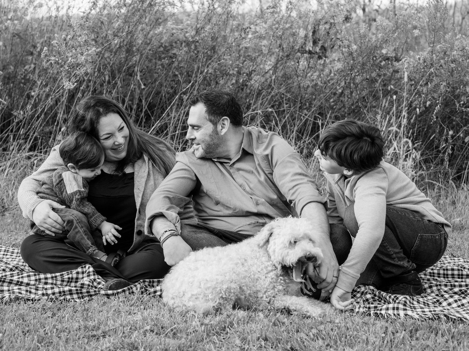 Black and white photo of family of four with their dog in Baltimore, MD