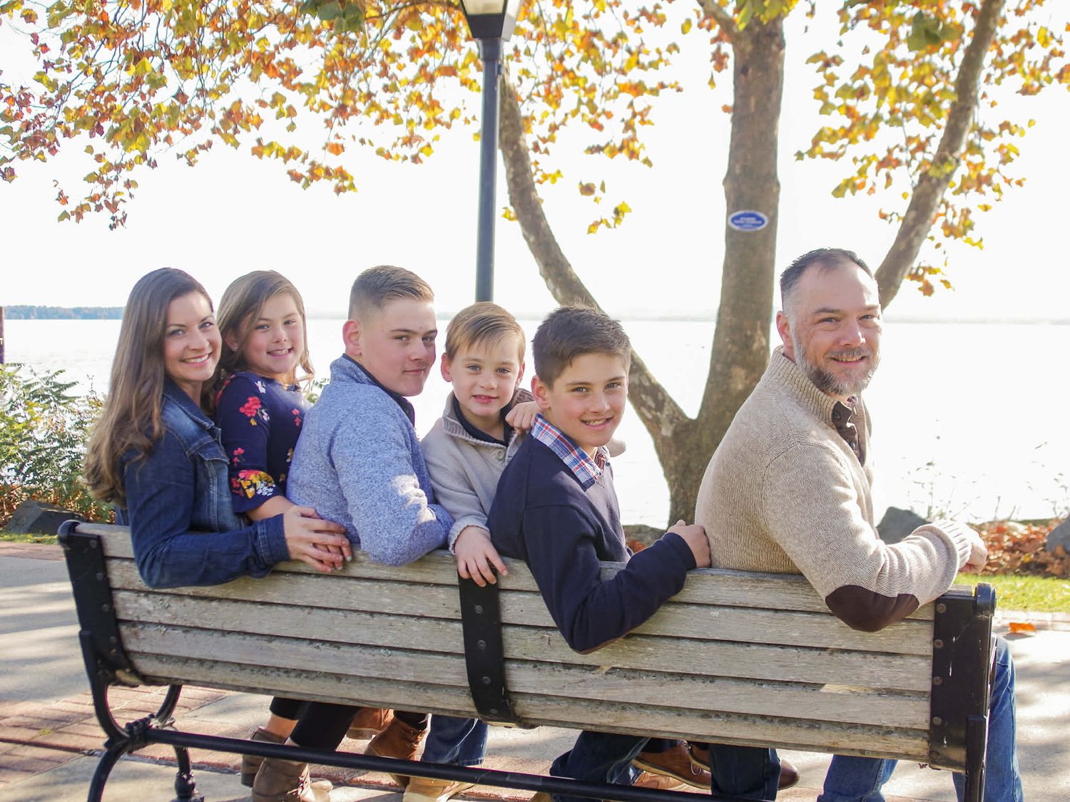 Family photo session with family sitting on a park bench in Havre de Grace, MD