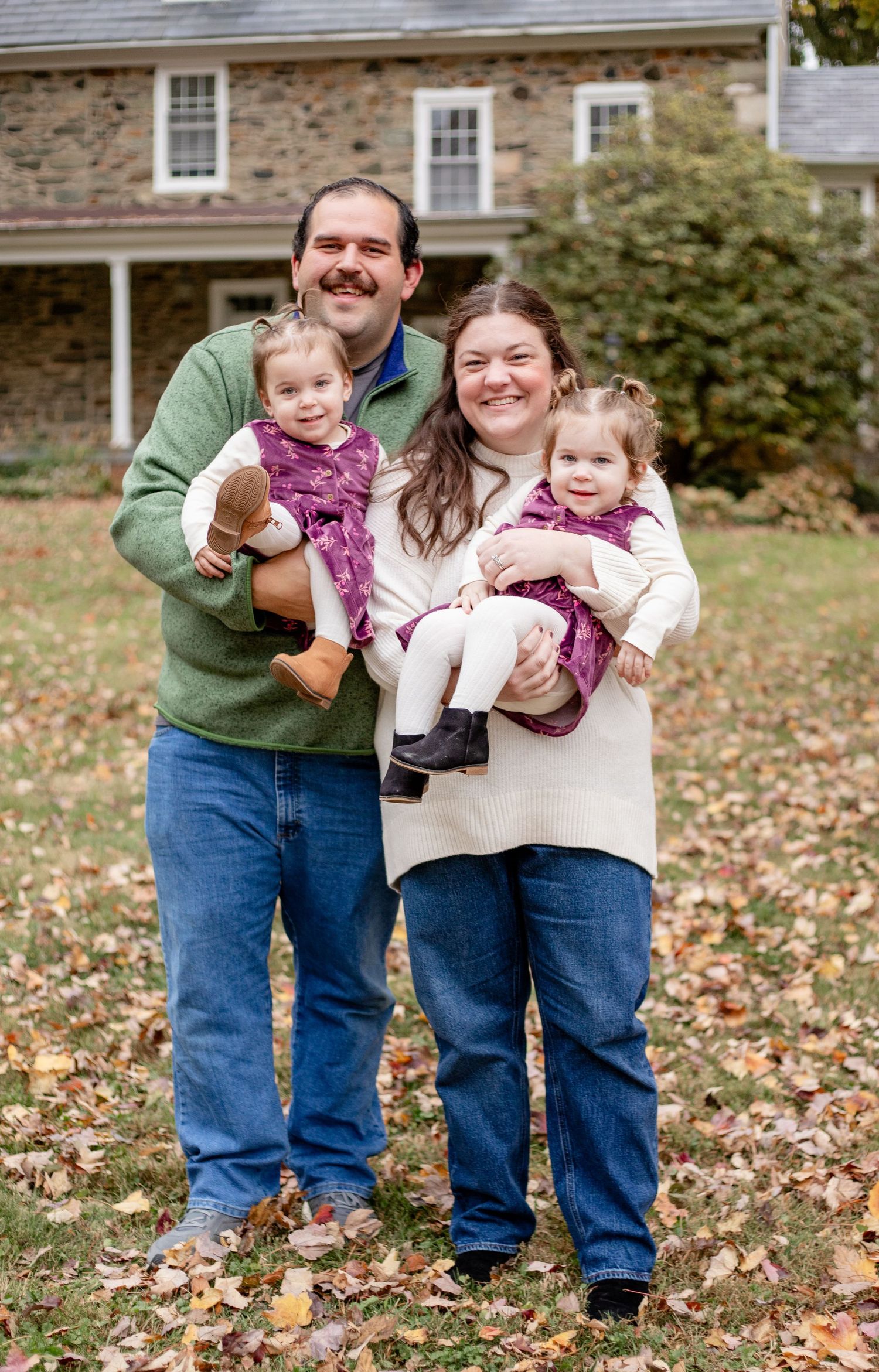 Mom and Dad with twin girls during family photo session