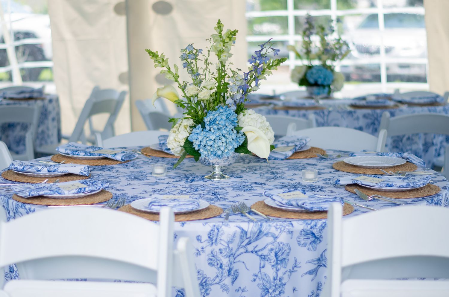 Wedding photo of blue and white tables with hydrangea centerpieces in Sparrows Point, MD