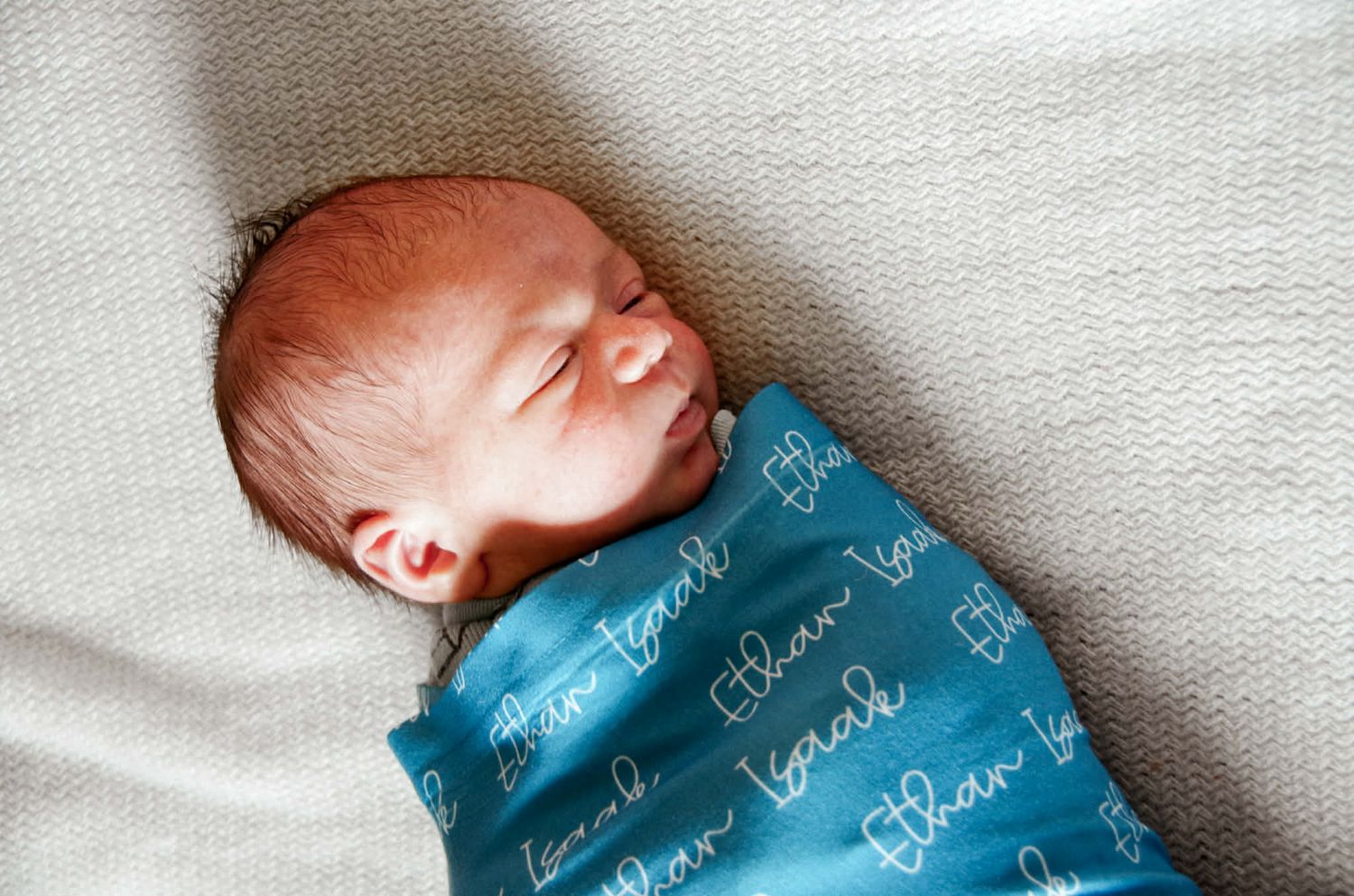Newborn baby photo session with baby in swaddle in Baltimore, MD