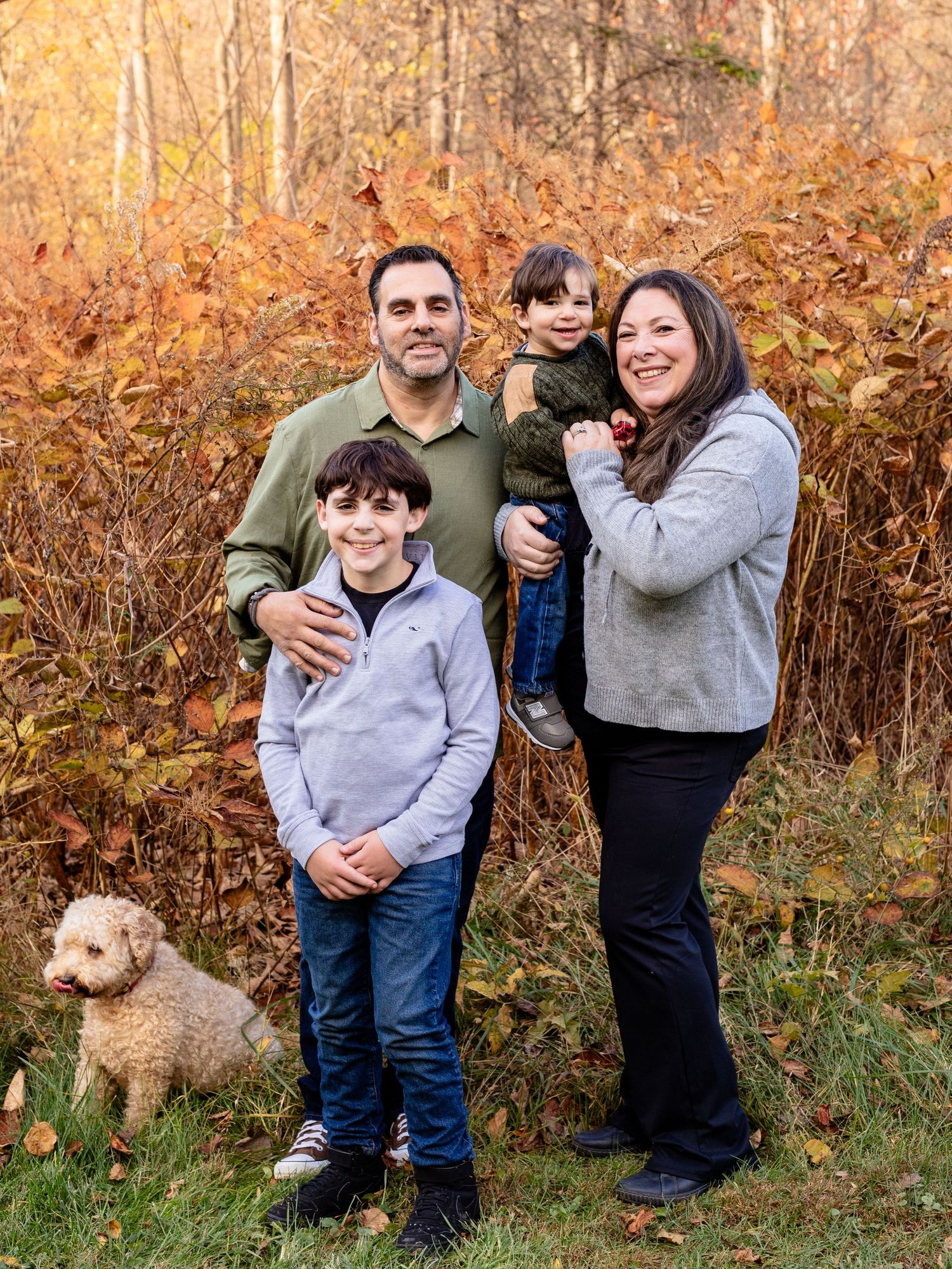 A family of four with their dog during a family photo session in Baltimore County, MD