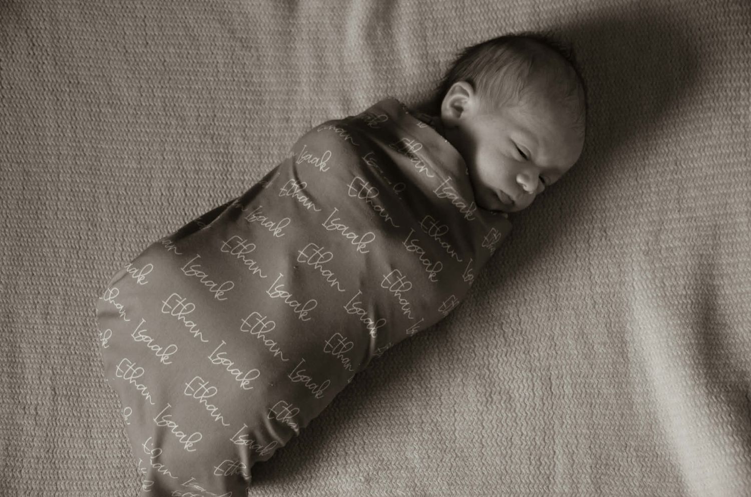 Newborn baby photo session with baby in swaddle in Baltimore, MD