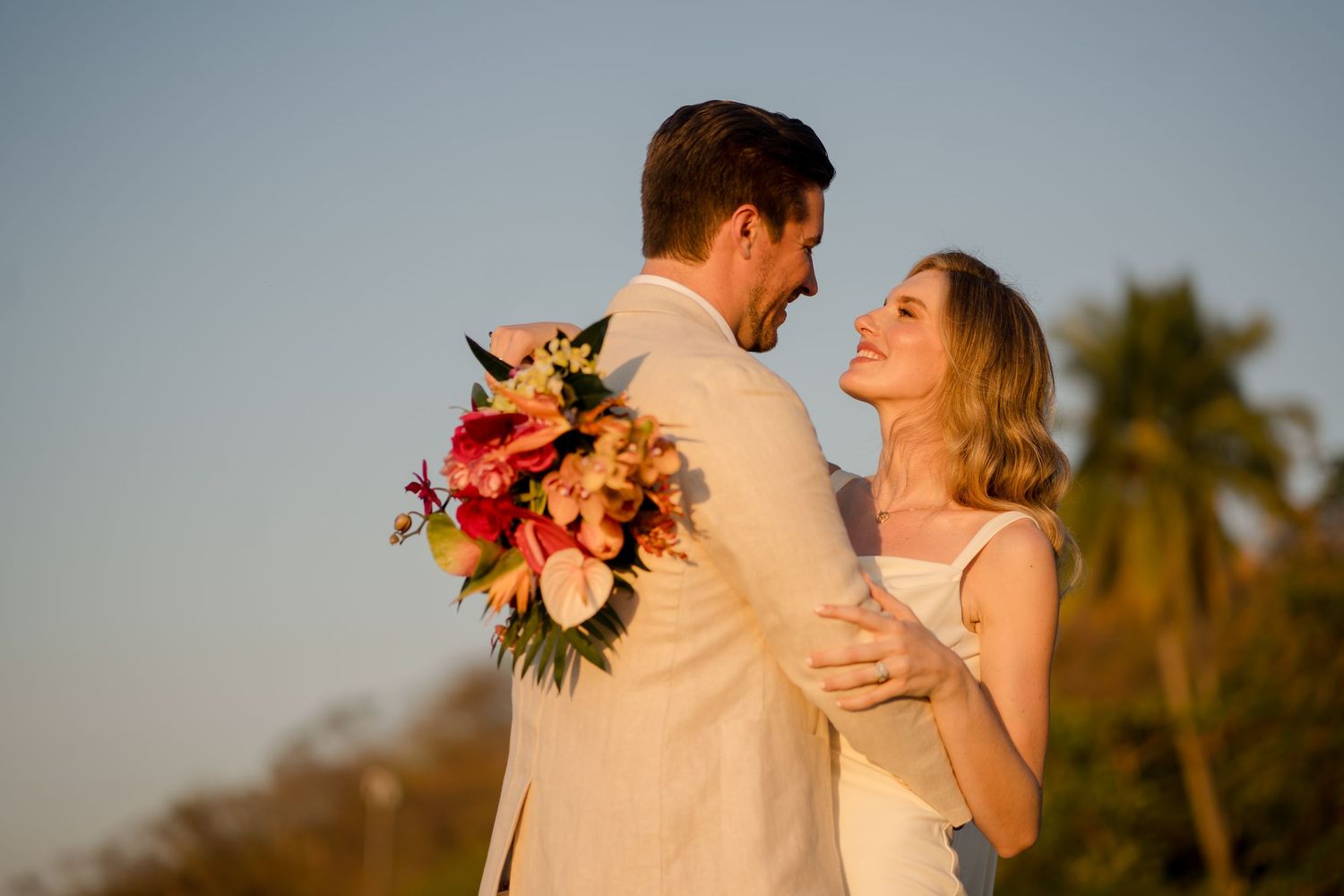 Golden hour couple portrait during a luxury destination wedding in Guanacaste, Costa Rica with vibrant tropical florals.