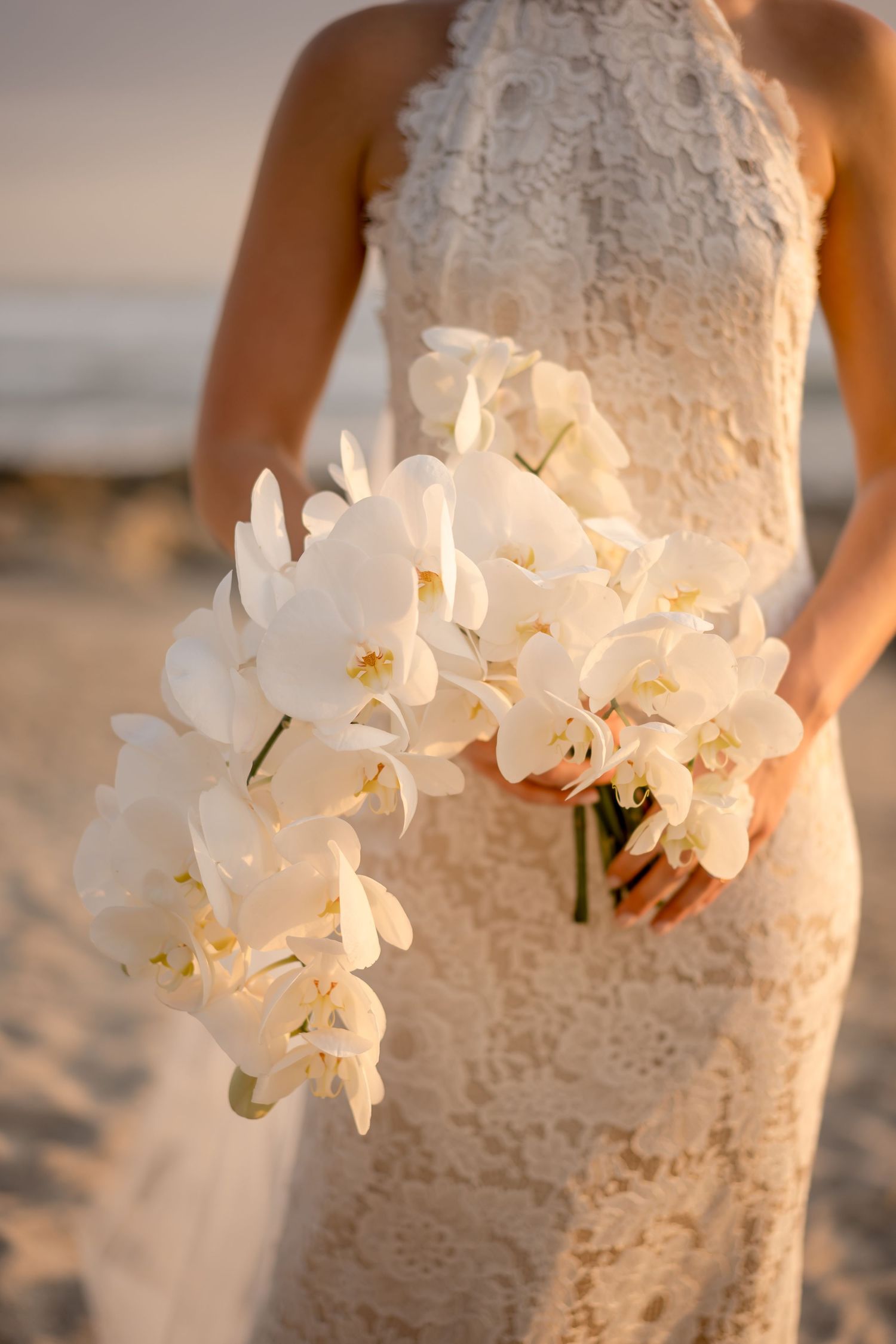 Elegant white orchid bridal bouquet photographed during a luxury destination wedding in Costa Rica.