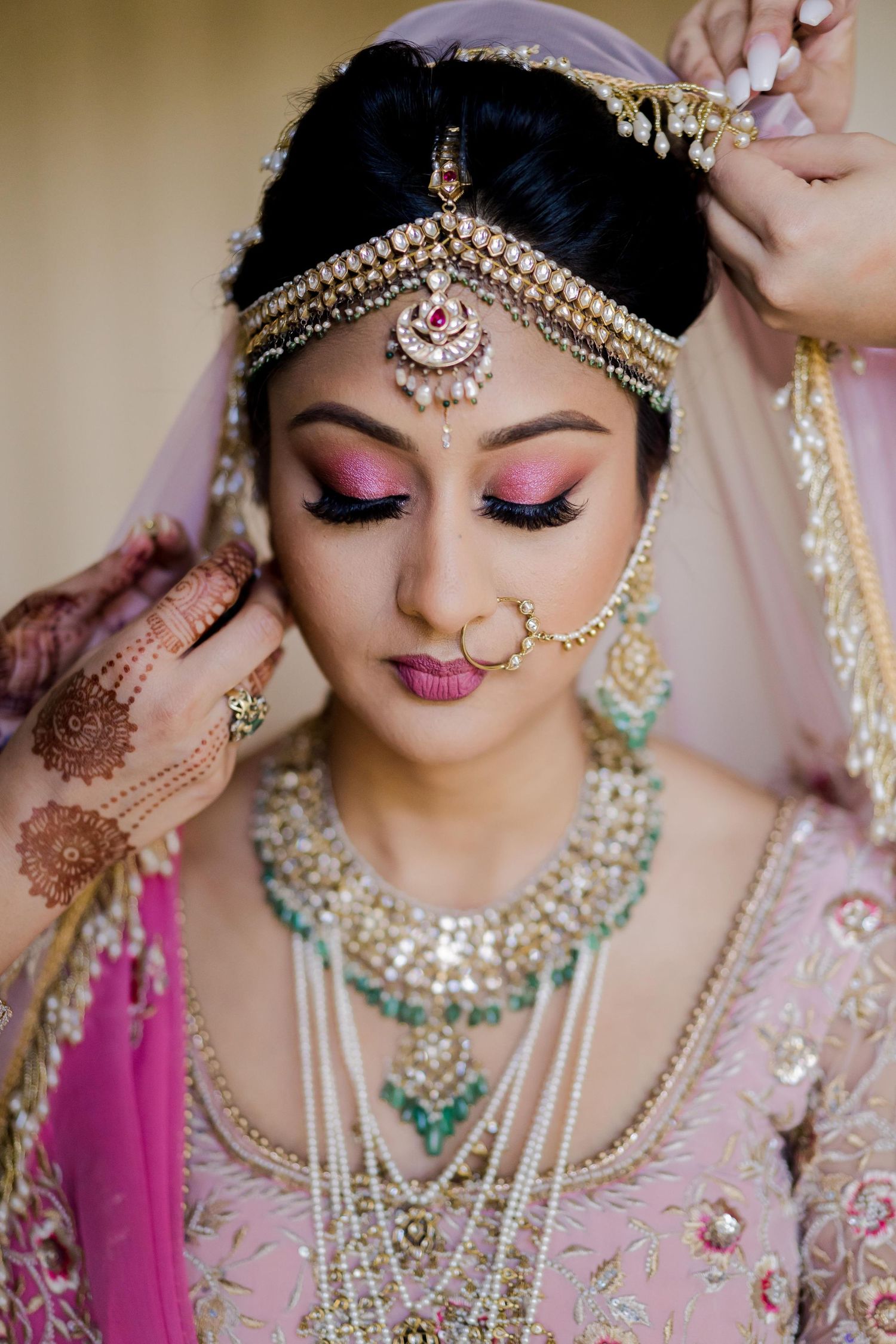 South Asian bride wearing handcrafted Hindu bridal jewelry and traditional wedding attire during final bridal preparations in Andaz Hotel.