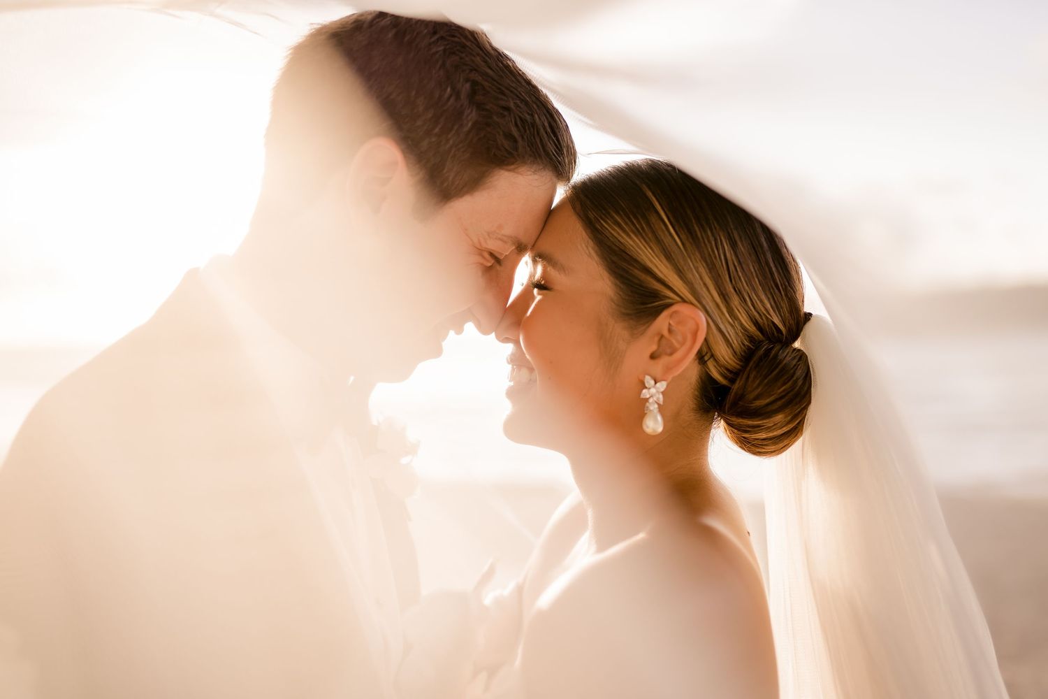 Intimate bride and groom portrait in warm golden light during a luxury destination wedding in Costa Rica.