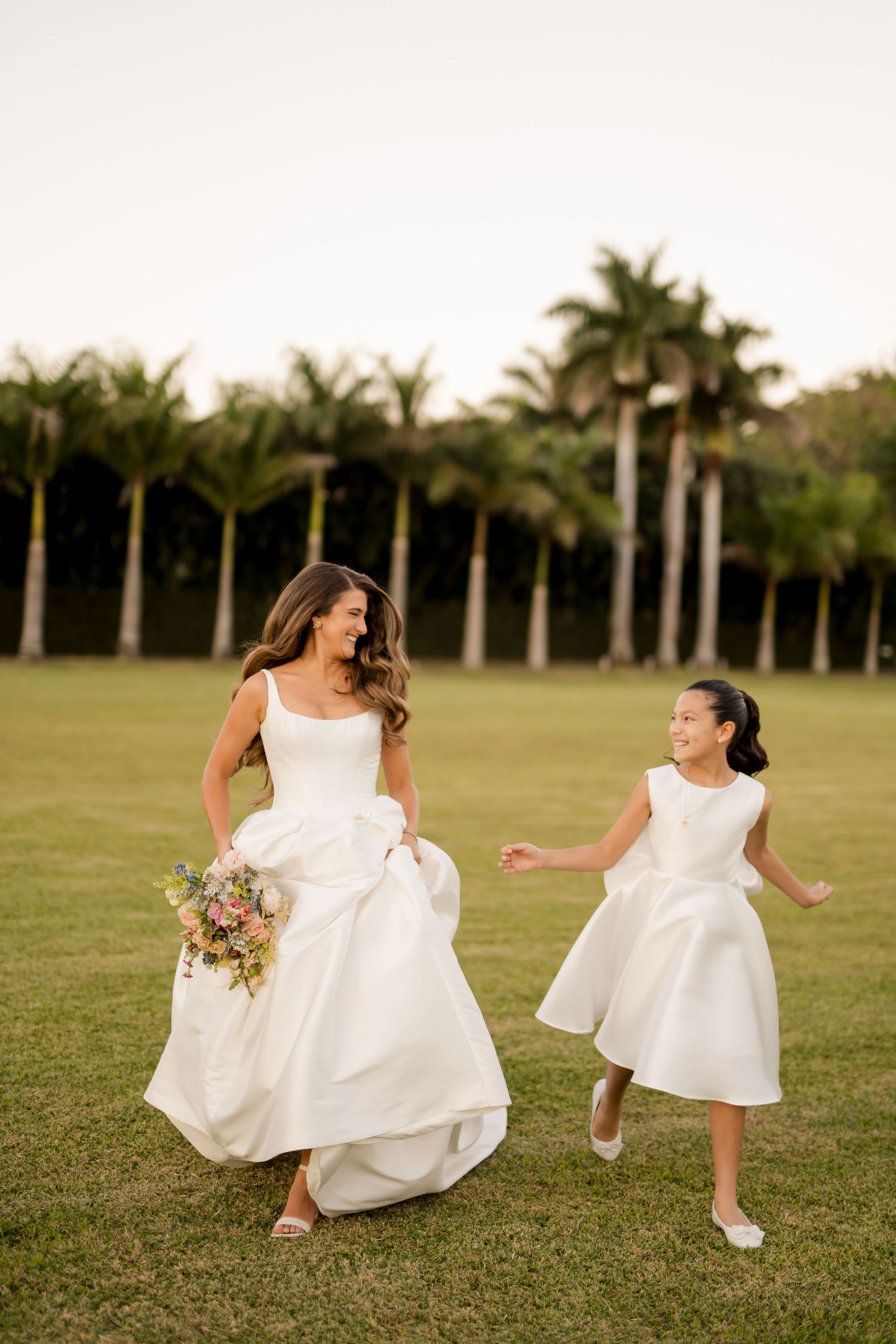 Bride walking hand in hand with her flower girl before the ceremony, celebrating one of the most meaningful moments of the wedding day.