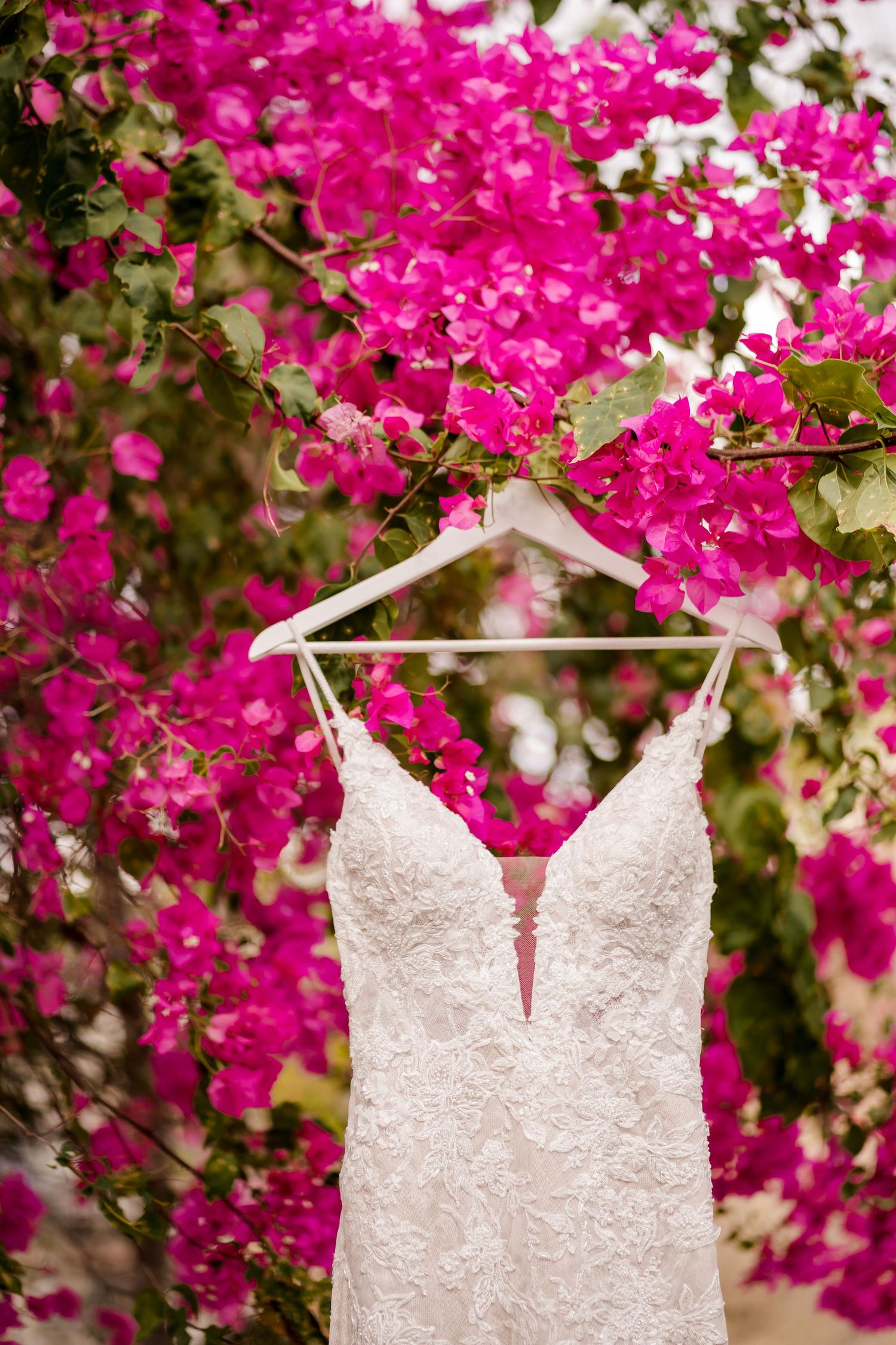 Wedding dress displayed beneath blooming bougainvillea for a luxury destination wedding in Las Catalinas, Guanacaste, Costa Rica.