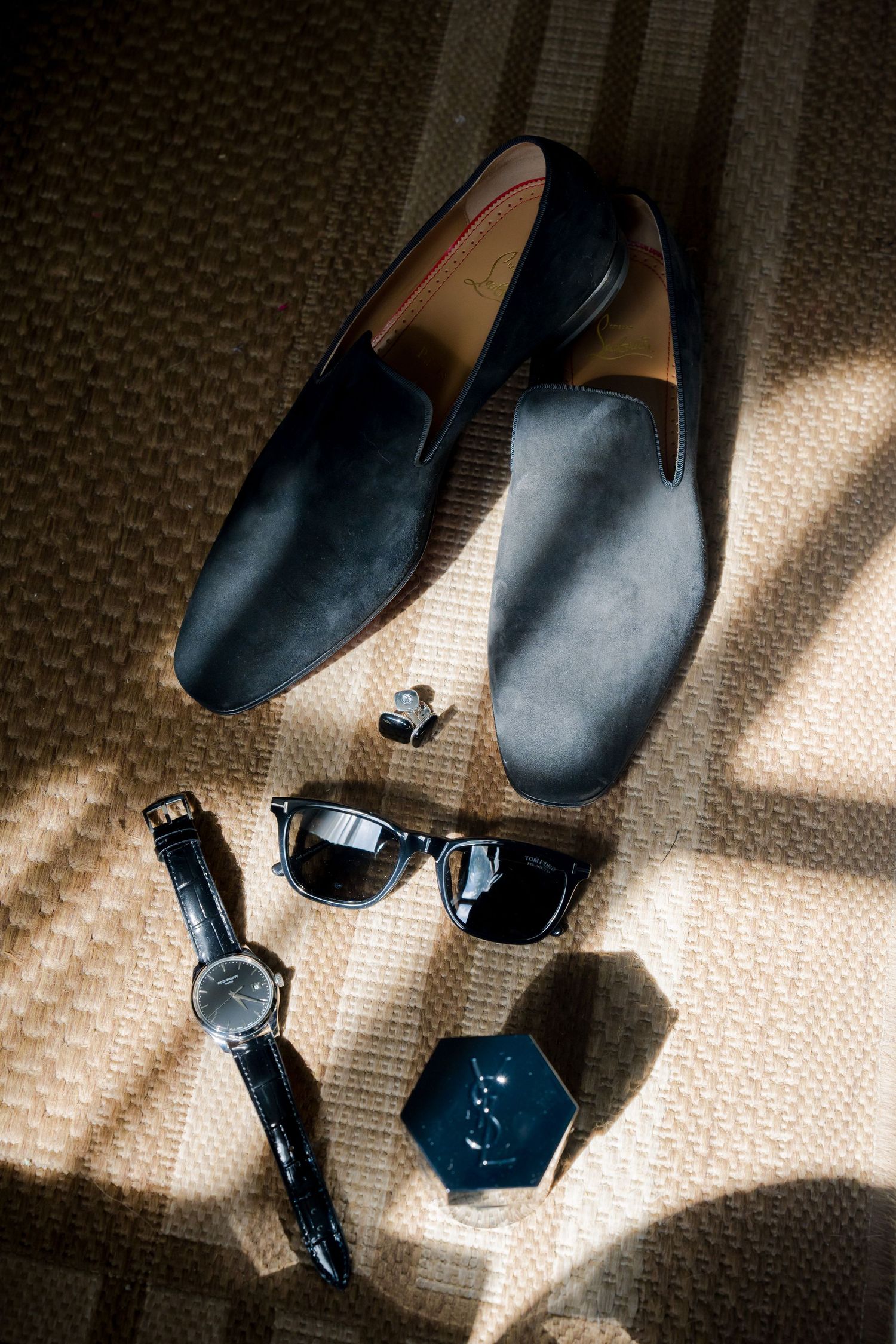 Luxury groom accessories including velvet loafers, watch, sunglasses, and cufflinks for a destination wedding in Costa Rica.