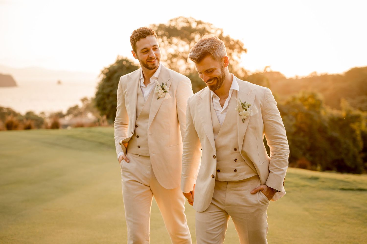 Stylish grooms walking together during golden hour after their luxury wedding celebration in Papagayo, Costa Rica.