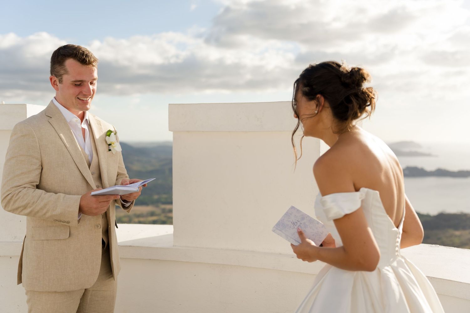 Bride and groom exchanging personal wedding vows during an intimate ocean view ceremony at sunset in Potrero Beach, Costa Rica.