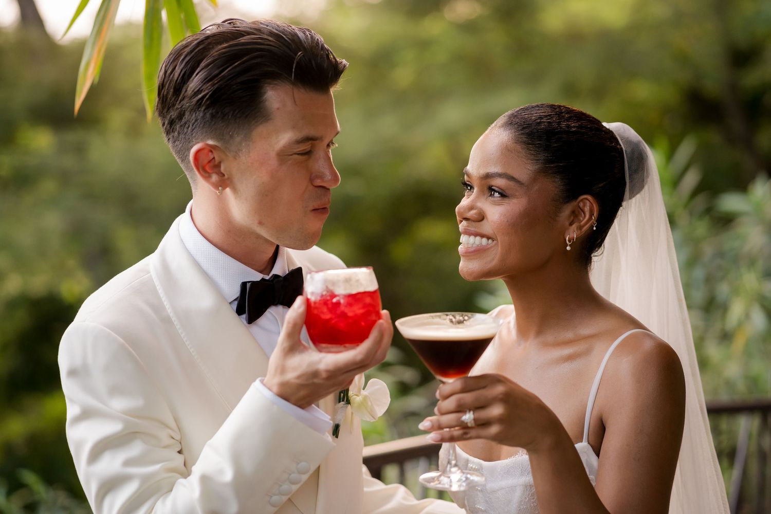 Newlyweds enjoying signature cocktails together during cocktail hour at their luxury destination wedding in Andaz Papagayo, Costa Rica.