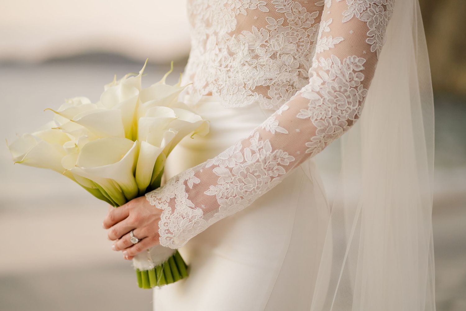 Elegant bridal portrait showcasing a timeless lace wedding gown and white calla lily bouquet during a luxury destination wedding in Papagayo
