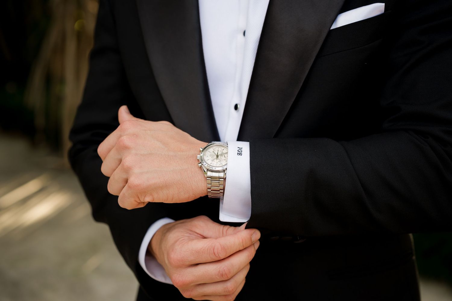 Classic groom details featuring a black tuxedo, luxury watch, and tailored wedding attire in Costa Rica.