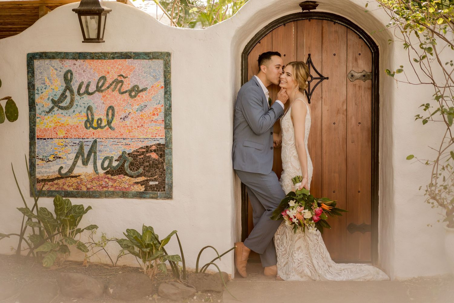 Couple sharing an intimate wedding portrait outside Boutique Hotel in Tamarindo, Guanacaste, following their luxury beach wedding