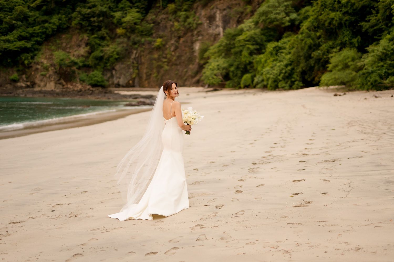Minimalist bridal portrait along a secluded tropical beach featuring a modern wedding gown and coastal scenery in Guanacaste, Costa Rica.