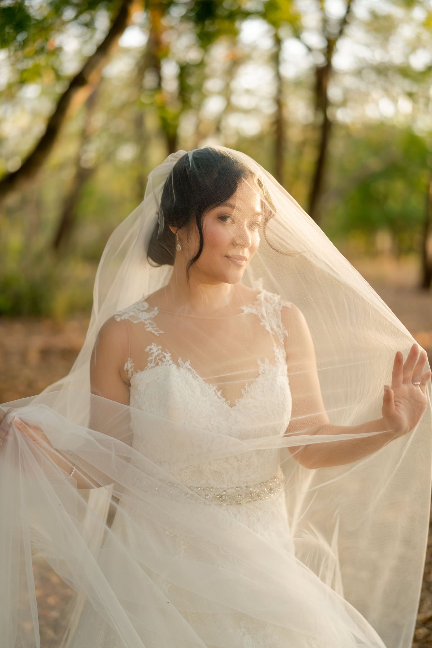 Soft bridal portrait framed by a flowing veil, highlighting timeless wedding fashion and natural elegance in Mangrove Hotel, Guanacaste.