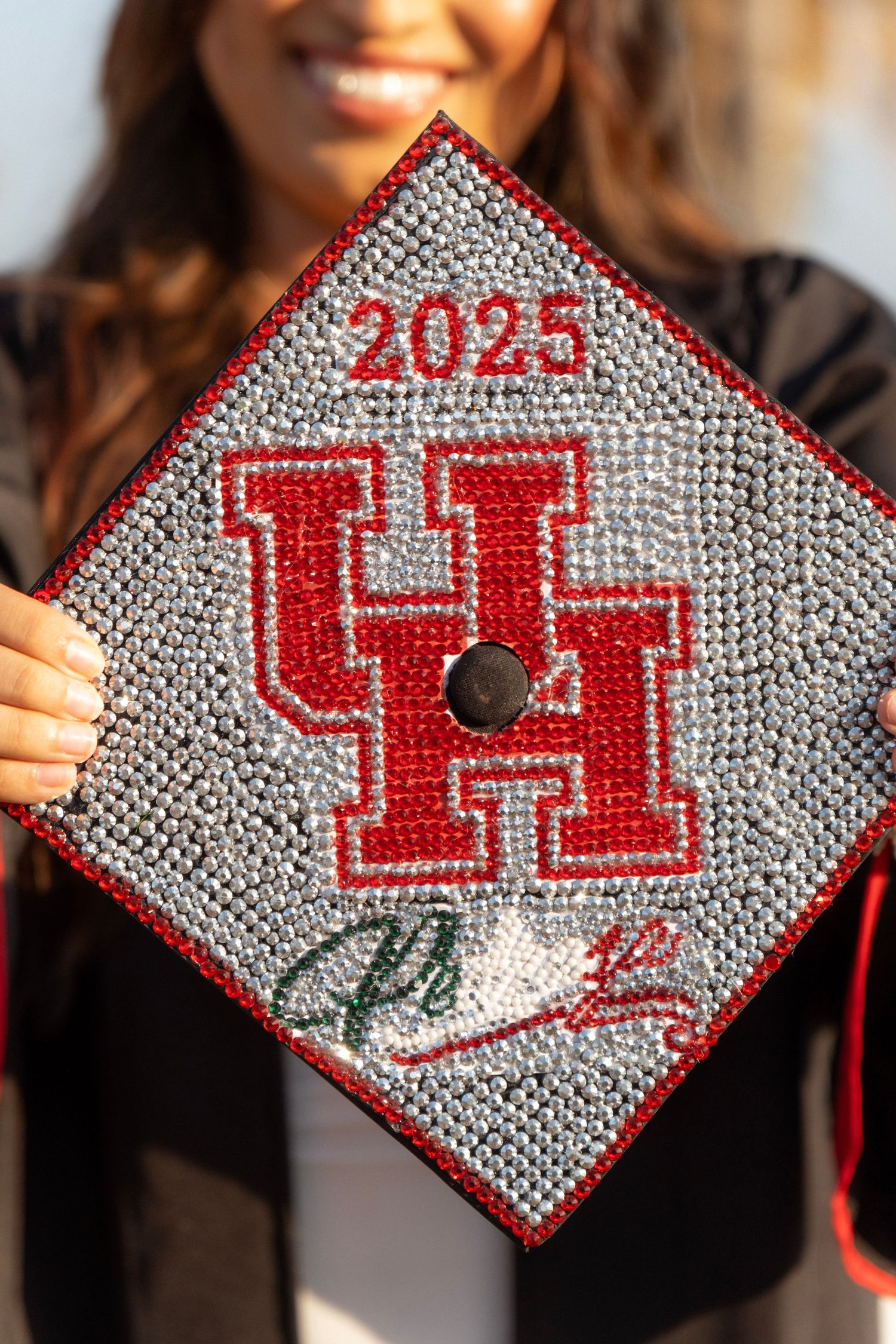 Bedazzled University of Houston graduation cap with UH logo and 2025 in red rhinestones.