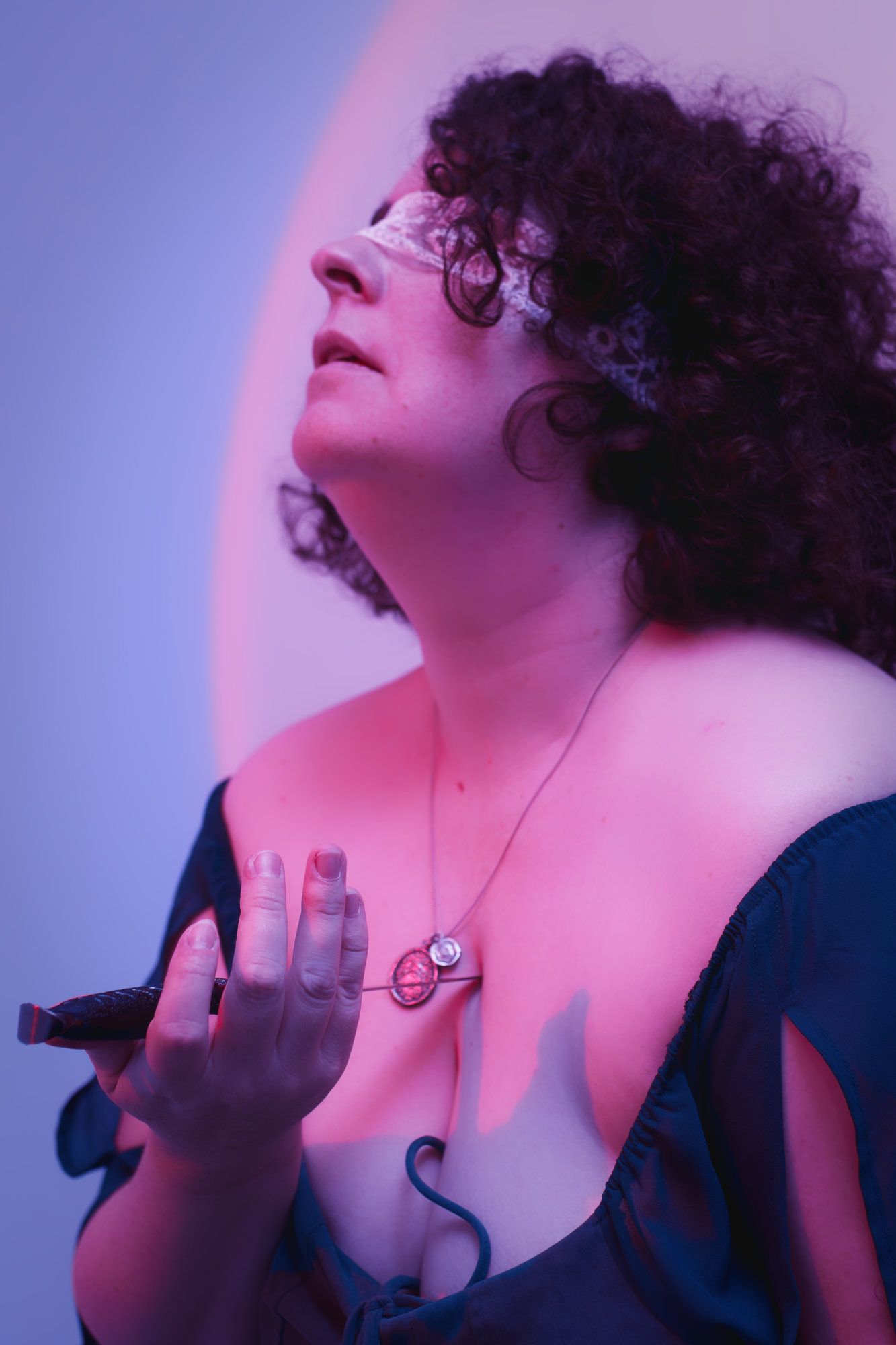 Fantasy photo of person holding a knife to their chest.