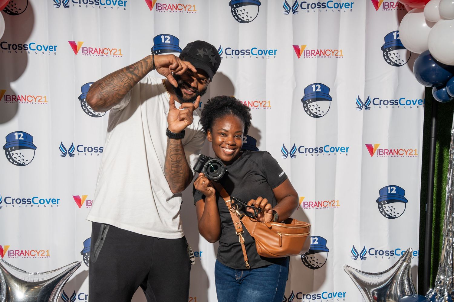 Nico Collins posing in front of CrossCover Vibrancy21 event backdrop. bratcher photography and houston photographer