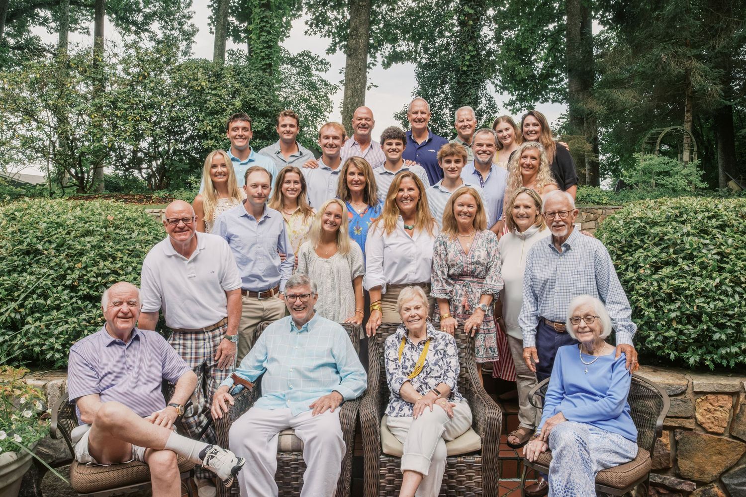 Extended family gathered together for a family reunion in East Tennessee with grandparents, parents, and grandchildren smiling outdoors.