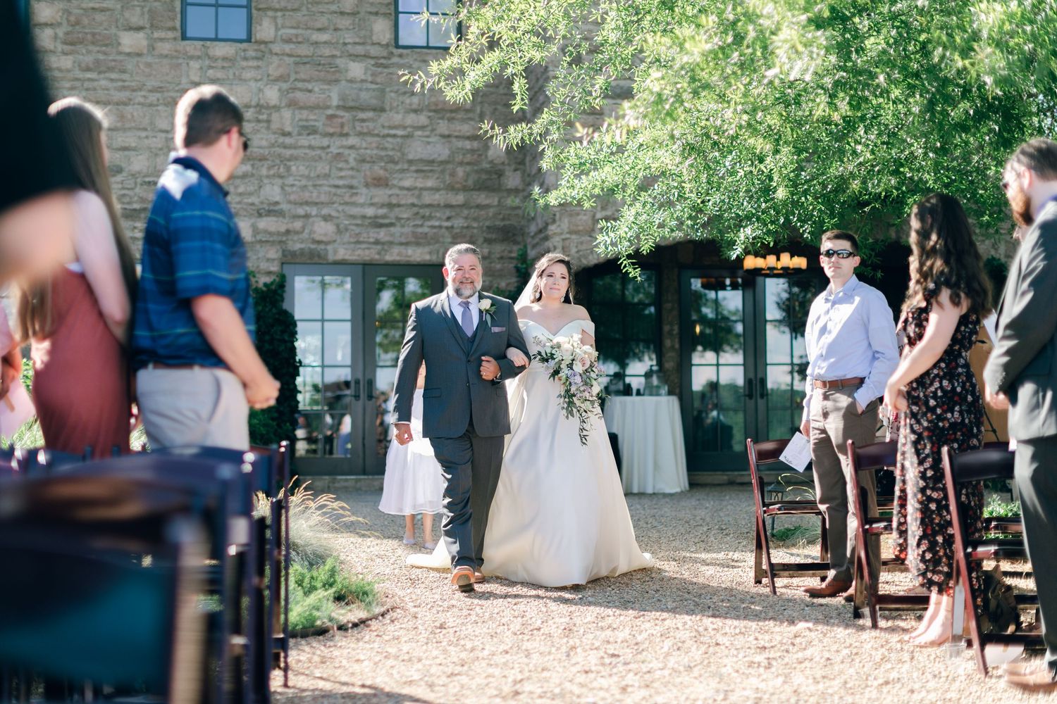 Bride and father walking down the aisle of ceremony at Chateau Selah wedding in Tennessee.